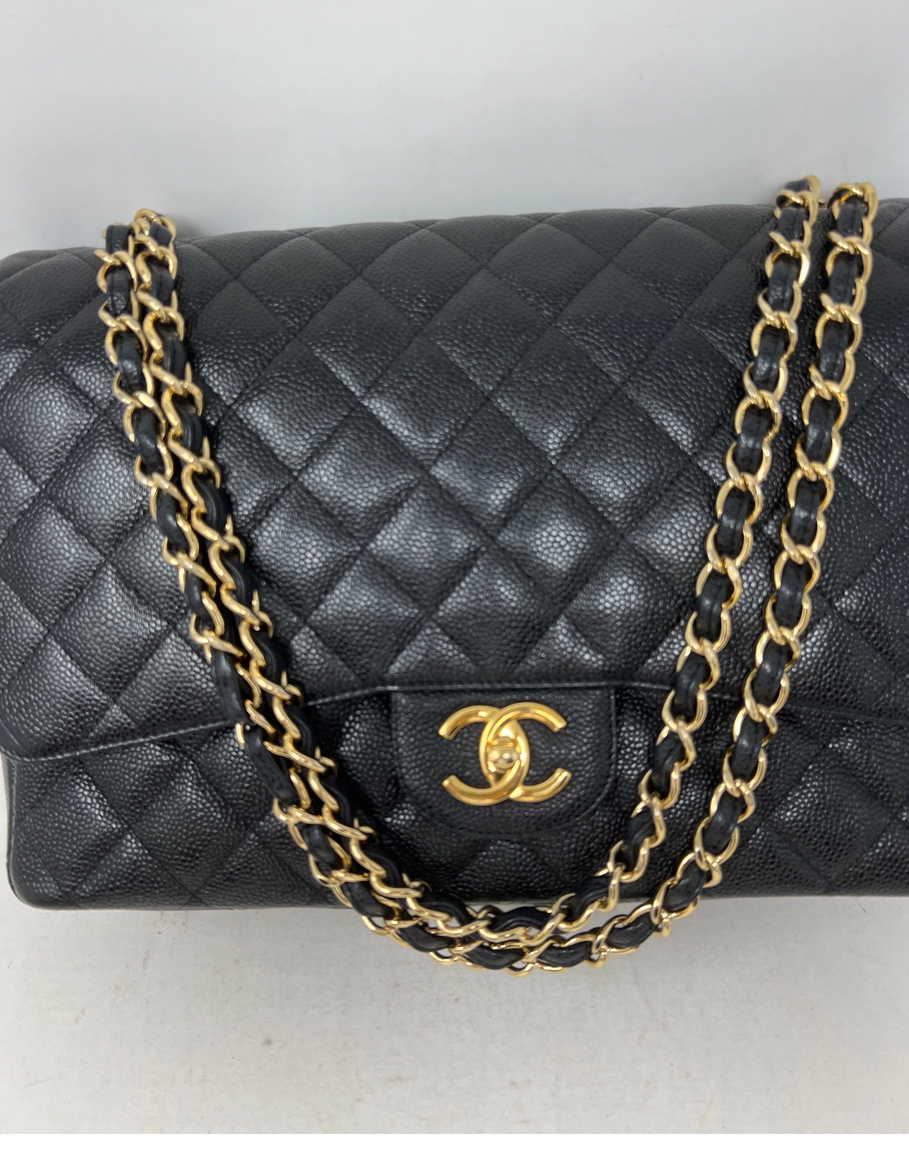 Chanel Black Maxi Caviar Bag. Gold hardware. Excellent condition. Bag looks like it was never carried. Amazing deal for a classic bag by Chanel. New at boutiques over $13,000 plus. Includes authenticity card, dust bag, and box. Full set. Guaranteed