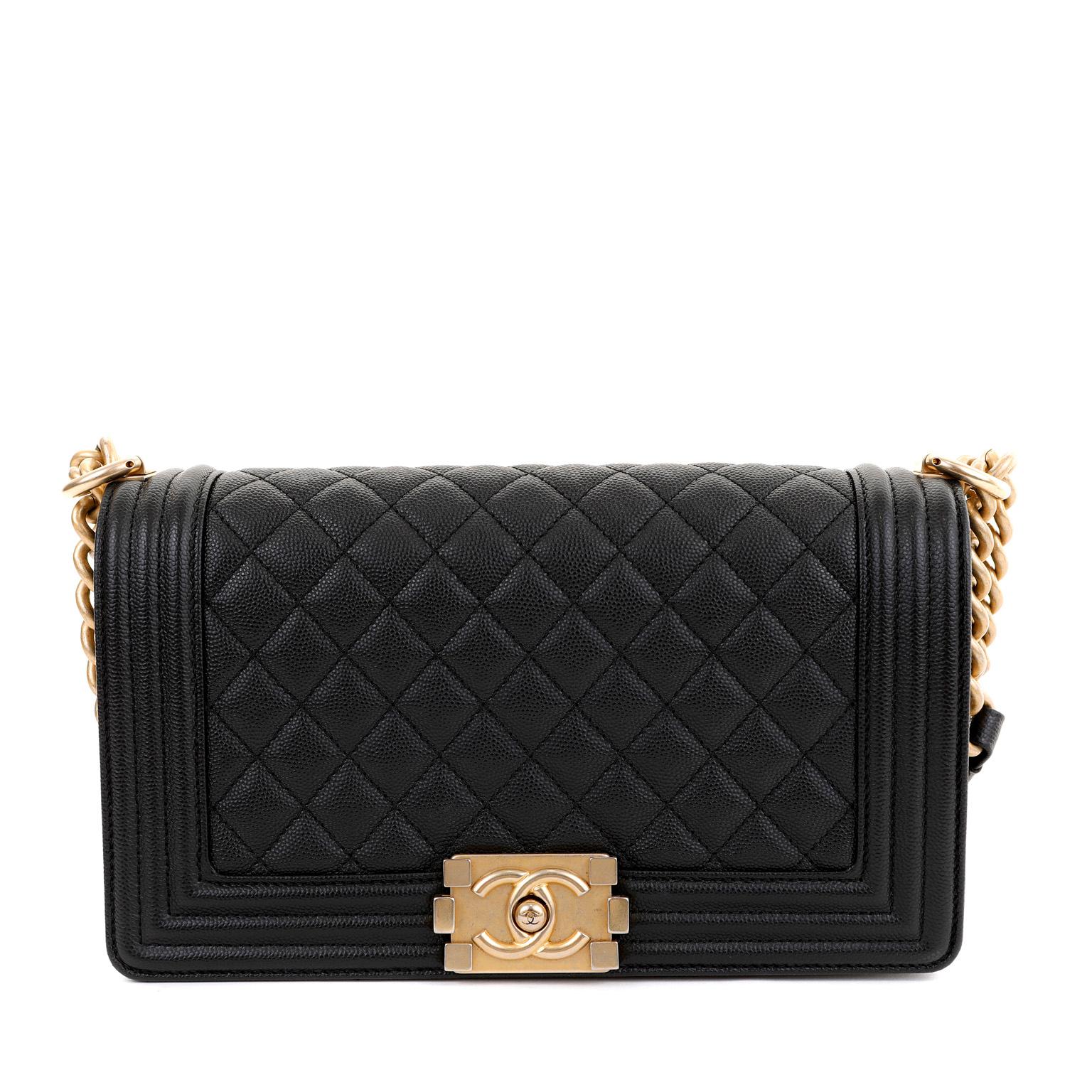 This authentic Chanel Black Caviar Medium Boy Bag is in pristine condition. The updated design is structured and edgy with a versatility that makes it extremely popular.  Black caviar leather is textured and durable. Further quilted in signature