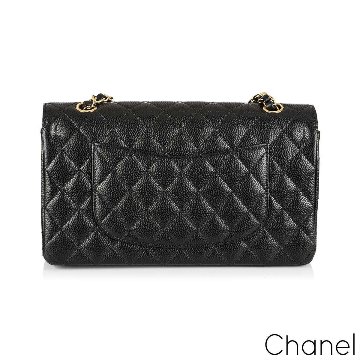A Timeless Chanel Classic Double Flap Handbag. The exterior of this medium classic is in black caviar leather with gold-tone hardware. It features a front flap with signature CC turnlock closure, half moon back pocket, and adjustable interwoven
