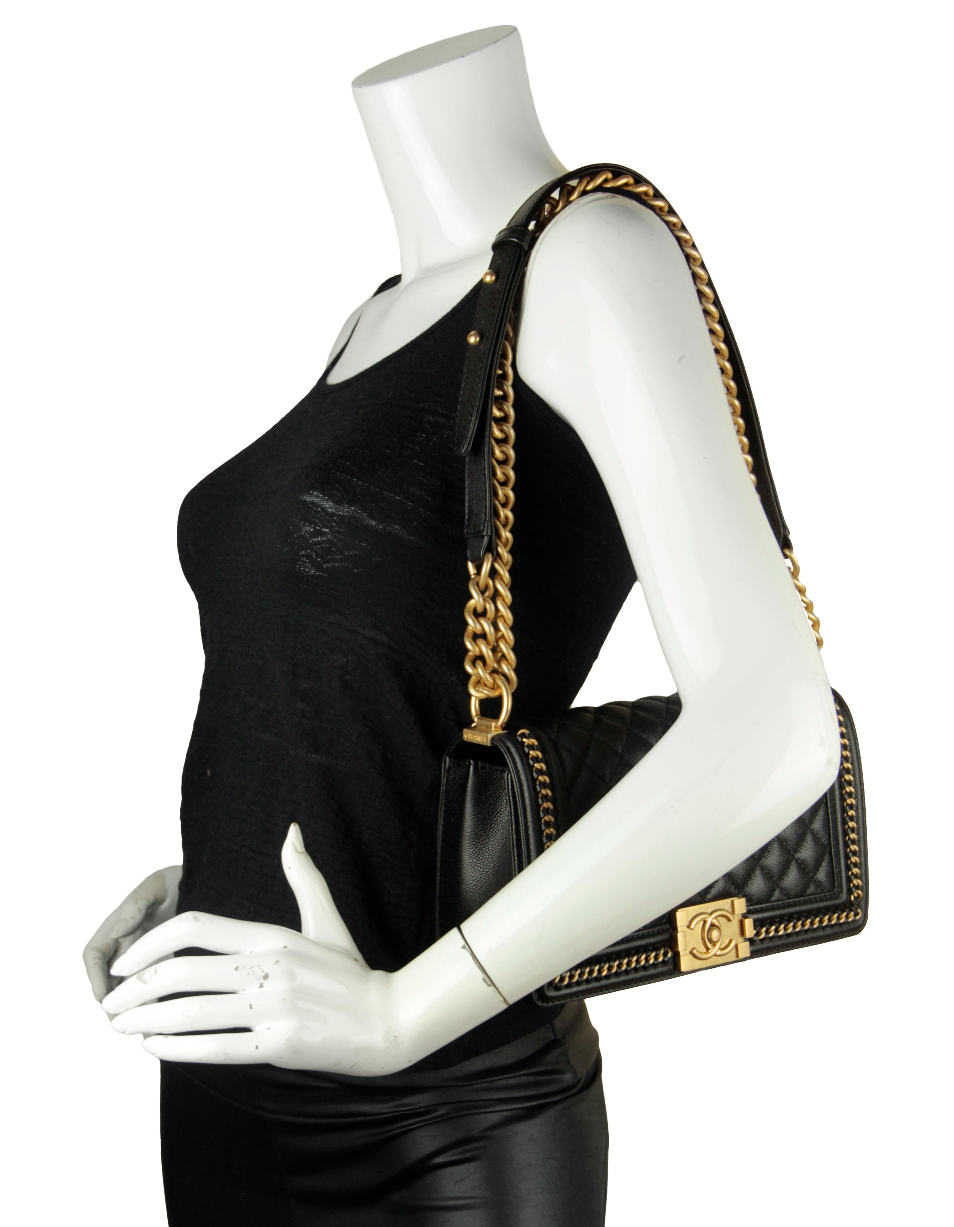 Chanel Black Caviar Quilted Medium Chain Through Boy Flap
Made In: France
Year of Production: 2021
Color: Black
Hardware: Goldtone
Materials: Caviar leather
Lining: Grosgrain
Closure/Opening: Flap top with CC pushlock
Exterior Pockets: None
Interior