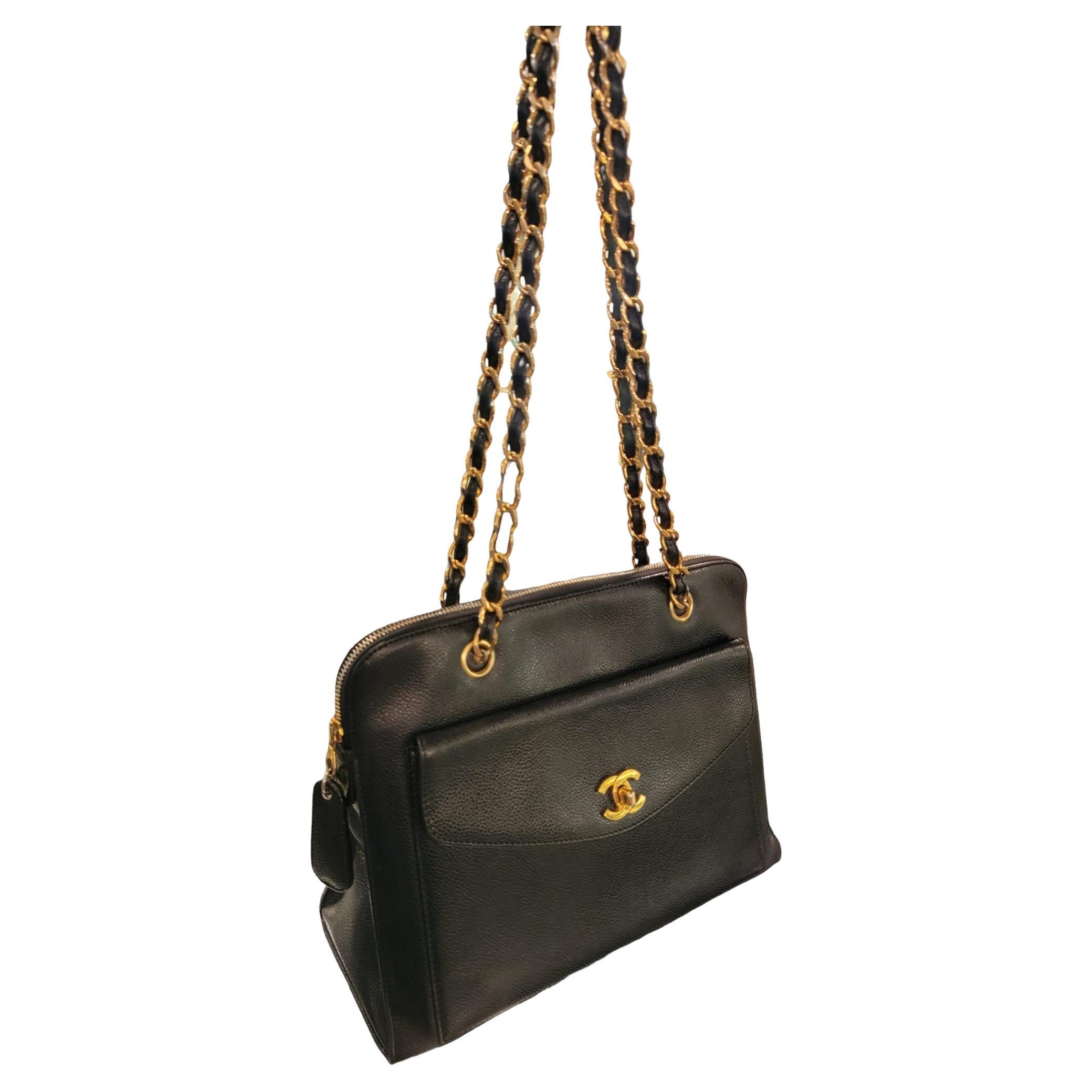 CHANEL Black Caviar Skin Leather Shoulder Bag With beautiful gold CC buckle accents on the front Of the bag. When opened exposes the exterior compartment. The caviar leather is used thorough he entire bag. The zipper enclosure has a hanging caviar
