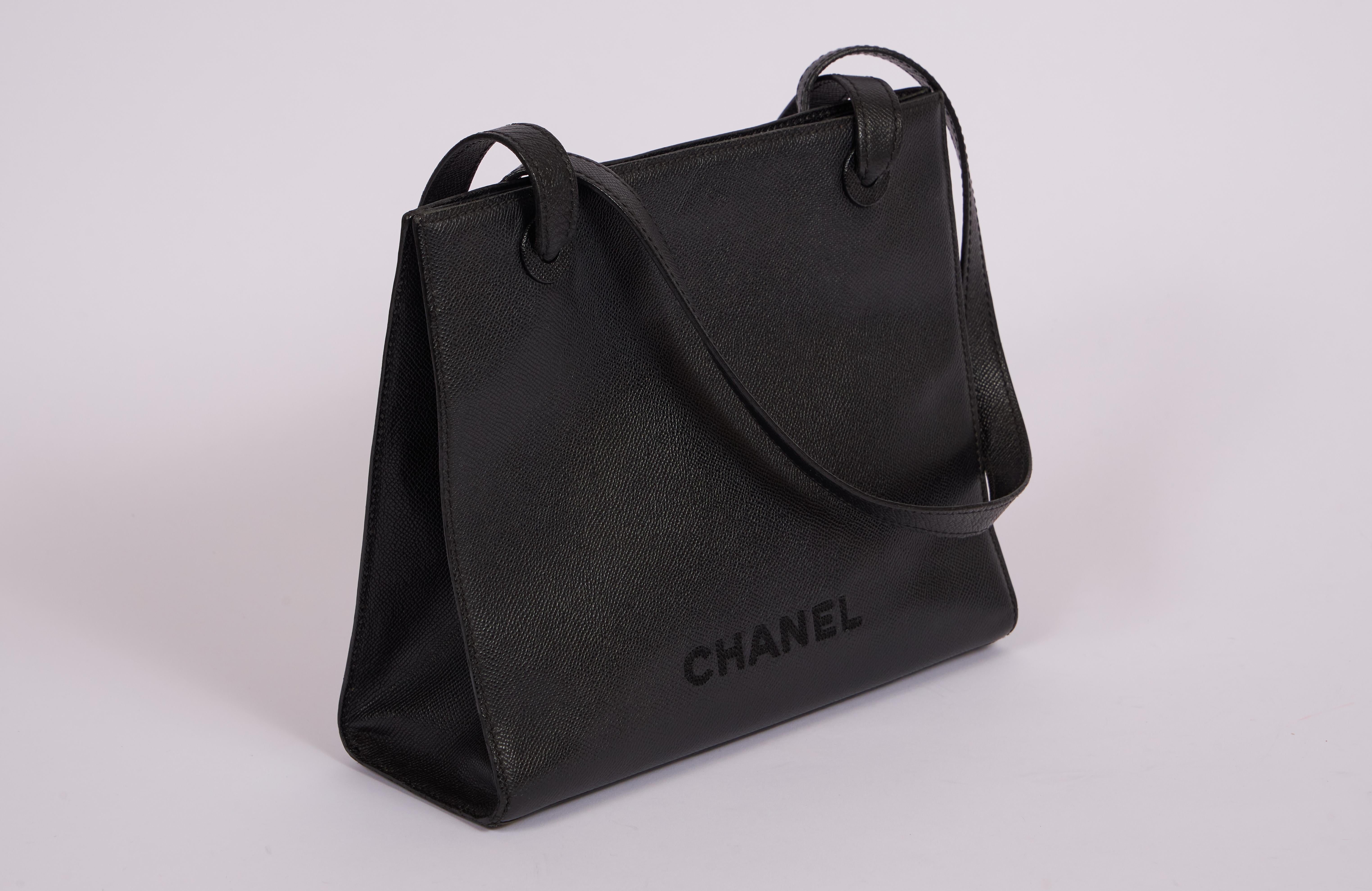 Chanel black caviar leather trapeze shoulder bag. 2 interior  zipped pockets. Shoulder drop 11