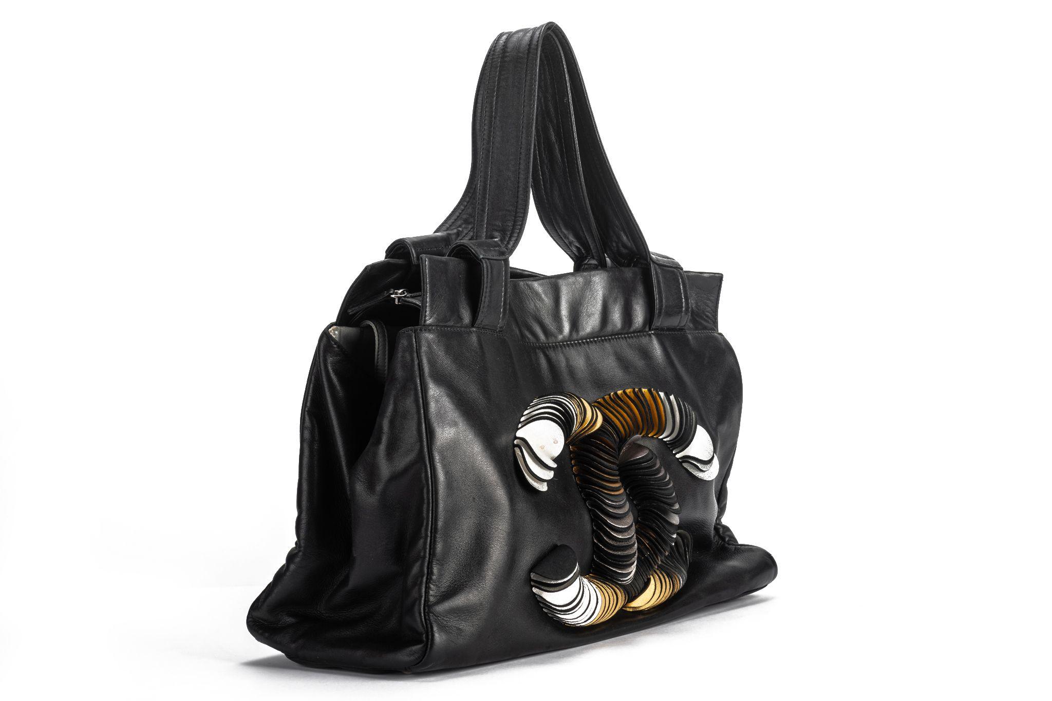 Chanel black Lambskin shoulder tote with gold discs from logo design. Shoulder drop 7”. Collection 12. Comes with hologram and original dust cover.