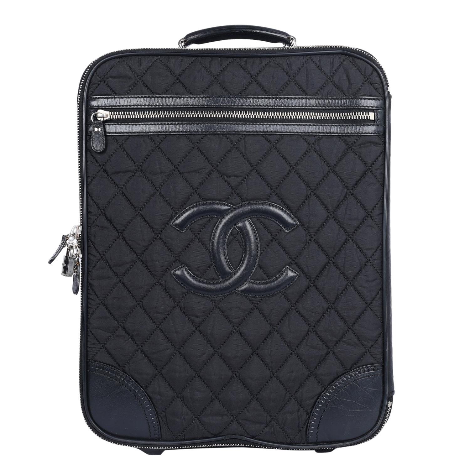 Authentic, pre-owned Chanel CC Rolling Trolley with Black Quilted Nylon and Leather accents. The main area is secured with a dual zipper closure with padlock,  silver hardware, front zipper pocket, top handle side handle, large interior with straps