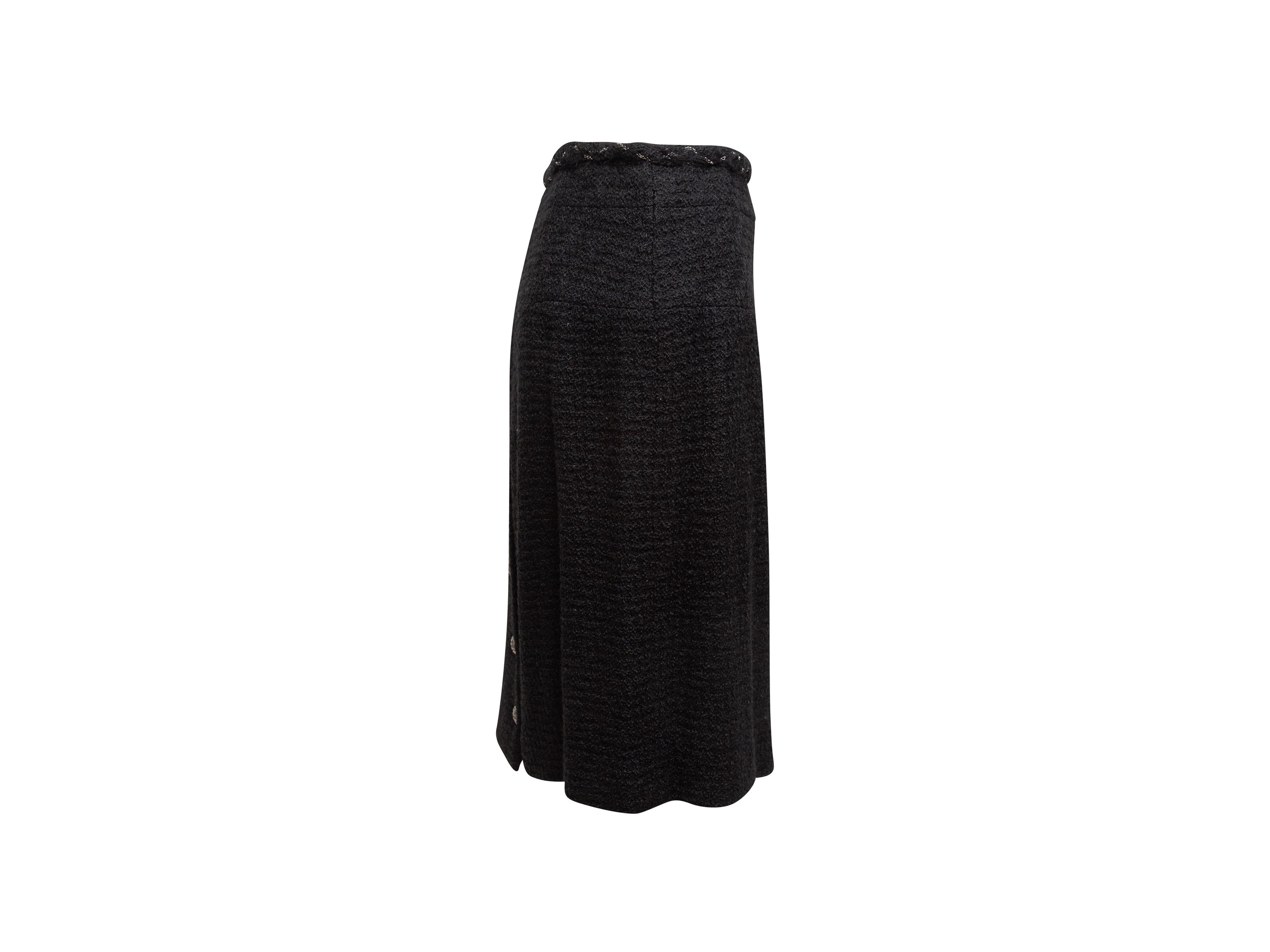 Product details: Black knee-length skirt by Chanel. Silver-tone chain-link accent detailing at waist. Silver-tone CC buttons at back vent. Zip closure at back. Designer size 50. 38