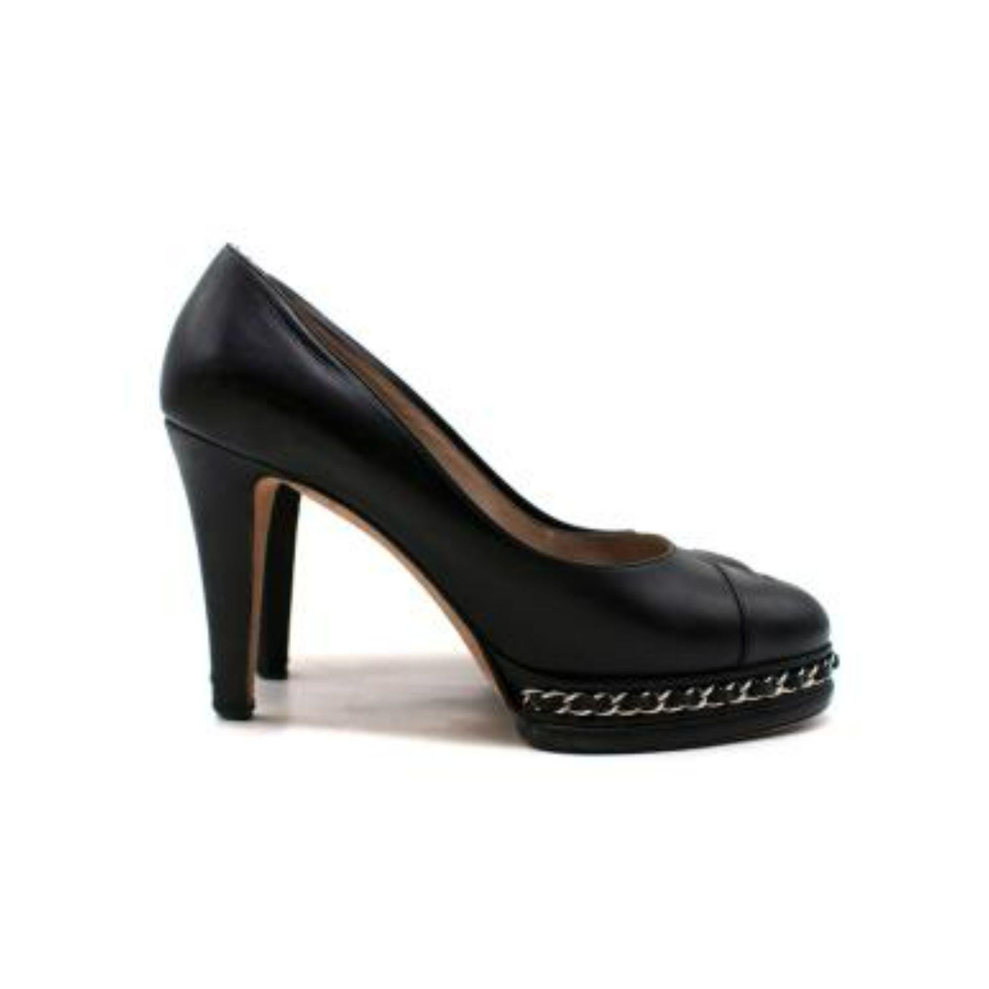 Chanel Black Chain Trimmed CC Pumps

-Chain detail on the platform 
-Branded leather insoles 
-Block heel 
-Round toe 

Material: 

Leather 

9.0/ Good conditions, some tear to the leather on the heel, please refer to images for further details.