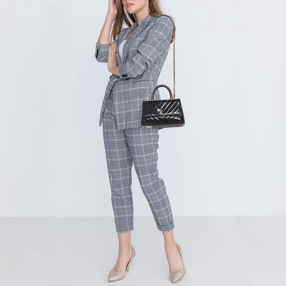 Ensure your days essentials are in order and your outfit is complete with this Chanel mini Coco top handle bag. Crafted using the best materials the bag carries the maisons signature of artful craftsmanship and enduring appeal.