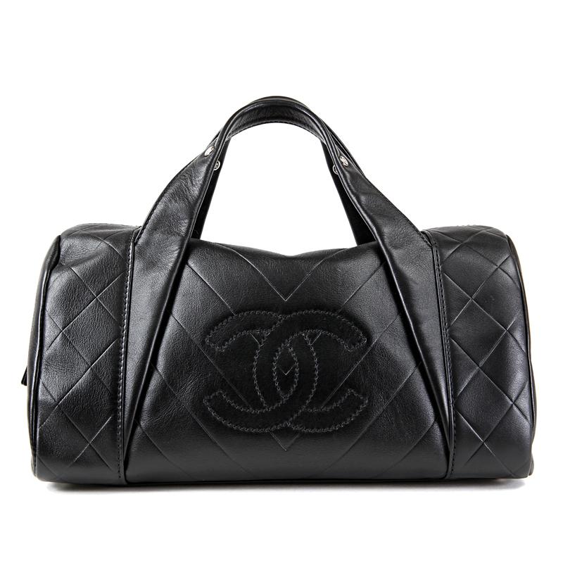 This authentic Chanel Black Chevron Leather All Day Long Boston Bag is in pristine unworn condition.  Black calfskin is quilted in chevron pattern.  Large interlocking CC is tonally stitched on the front.  Zippered top accesses the spacious fabric