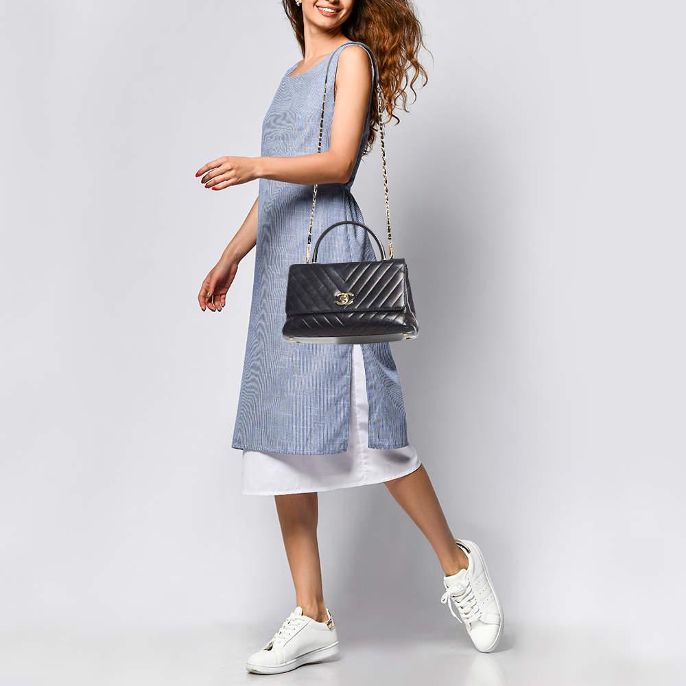 Ensure your days essentials are in order and your outfit is complete with this Chanel top handle bag. Crafted using the best materials the bag carries the maisons signature of artful craftsmanship and enduring appeal.