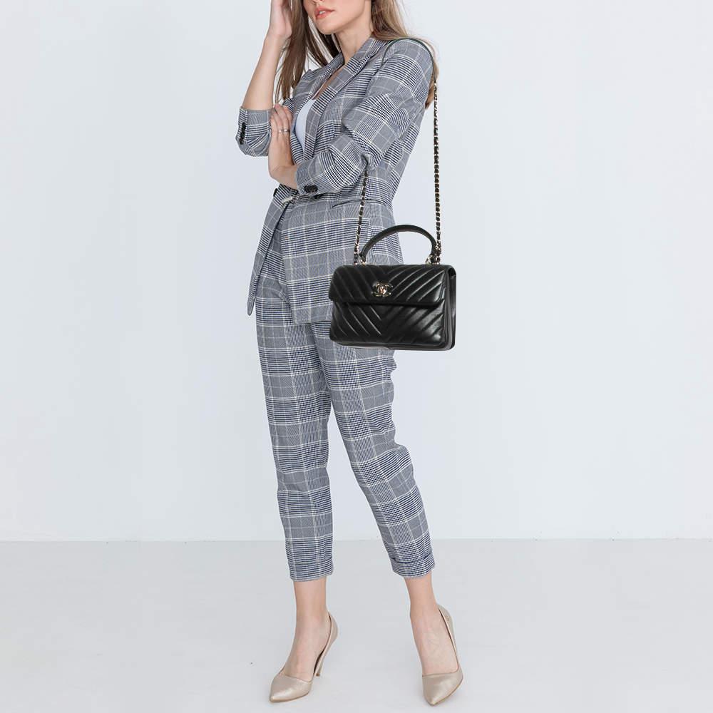 The Chanel Trendy CC Top Handle Bag is a chic and versatile accessory. Crafted from luxurious chevron quilted leather it features a sleek top handle iconic CC logo and gold tone hardware. With its timeless design and compact size this bag