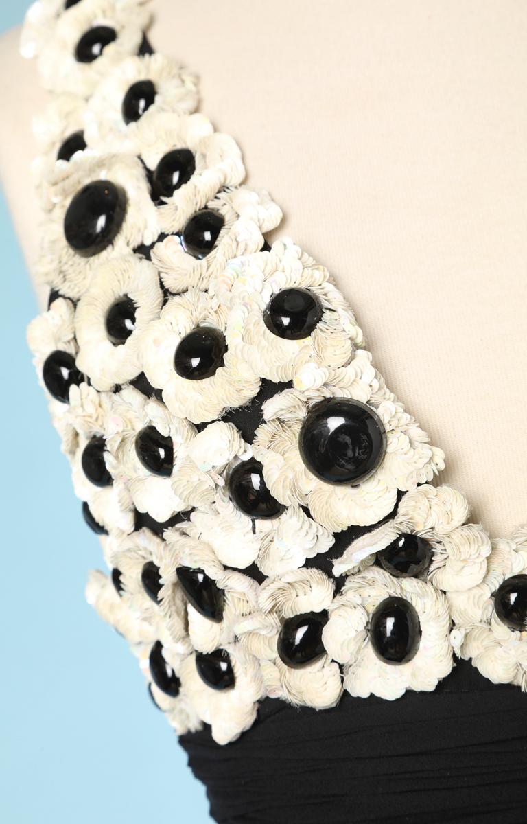Black chiffon dress, top in black and white sequined flowers, with a flounce on the hips. Branded Chanel