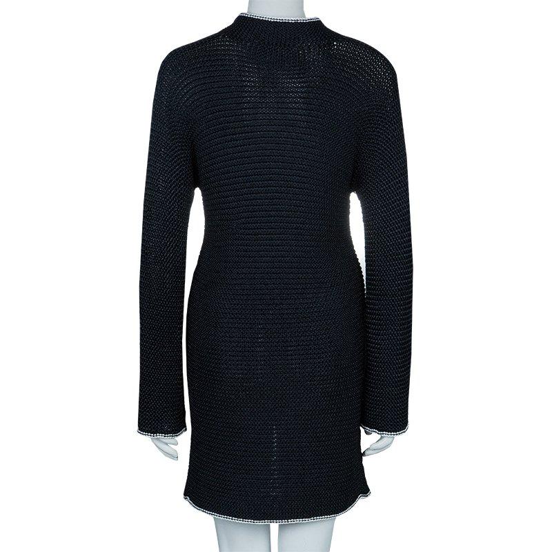Chanel is all set to impress you with this chic and classic Chunky Loose dress to win you those boundless gazes. Knitted from nylon, it features a laudable V shaped neckline with stand collars. This dress is accentuated with well suited long sleeves