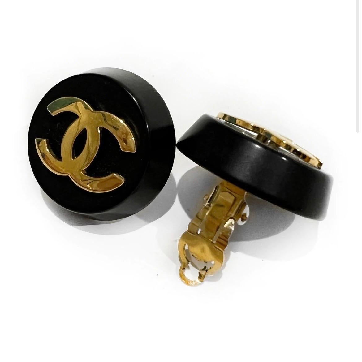 Black Circle Logo Clip On Earrings by Chanel 
Late 1980's- Early 1990's (collection 26 stamp)
Black resin sphere
Gold plated Chanel logo in center 
Made in France
Condition: Excellent vintage condition. Some small scratches on gold