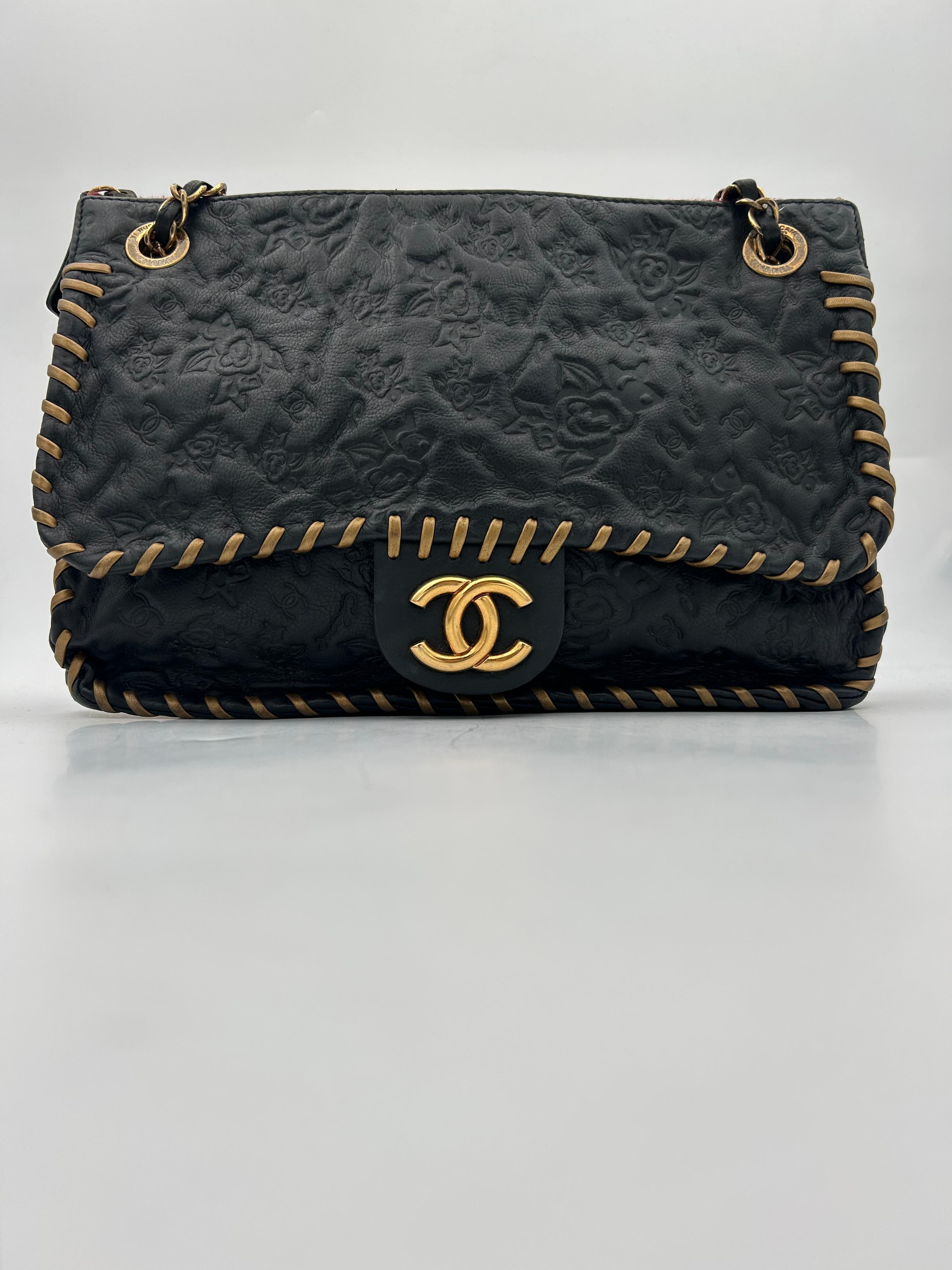 Chanel Black Classic Bag Camellia Blizzard 2010-2011. Please note this item is in good condition with minor wear consistent with age and use. Beautiful black leather bag in good condition. The camellia design is a perfect representation of the