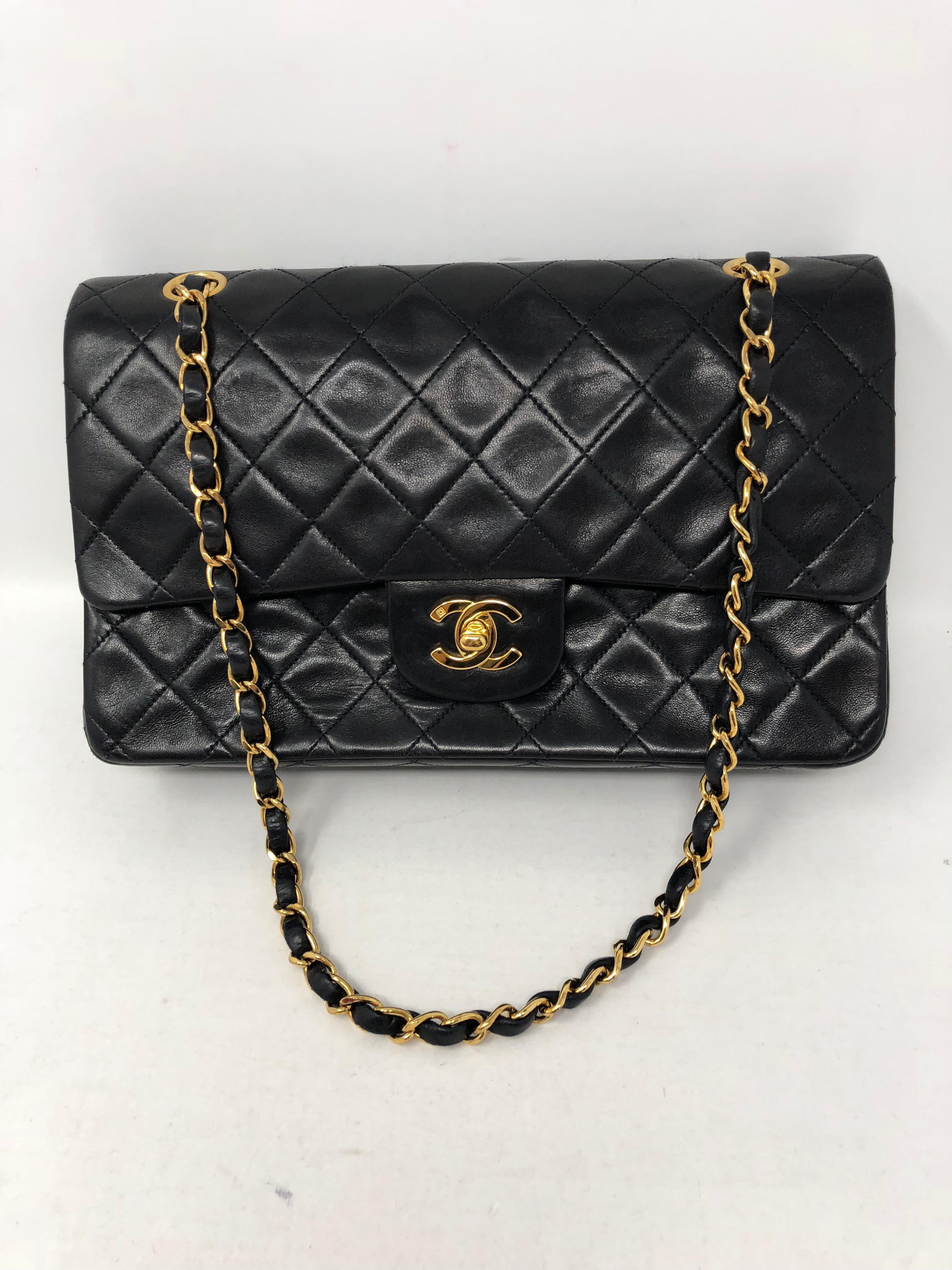 Chanel Black Classic Double Flap in medium size. Black lambskin leather with gold hardware. Burgundy interior. Double flap classic. Iconic classic never goes out of style. This one is in great vintage condition. Can be worn doubled or longer with