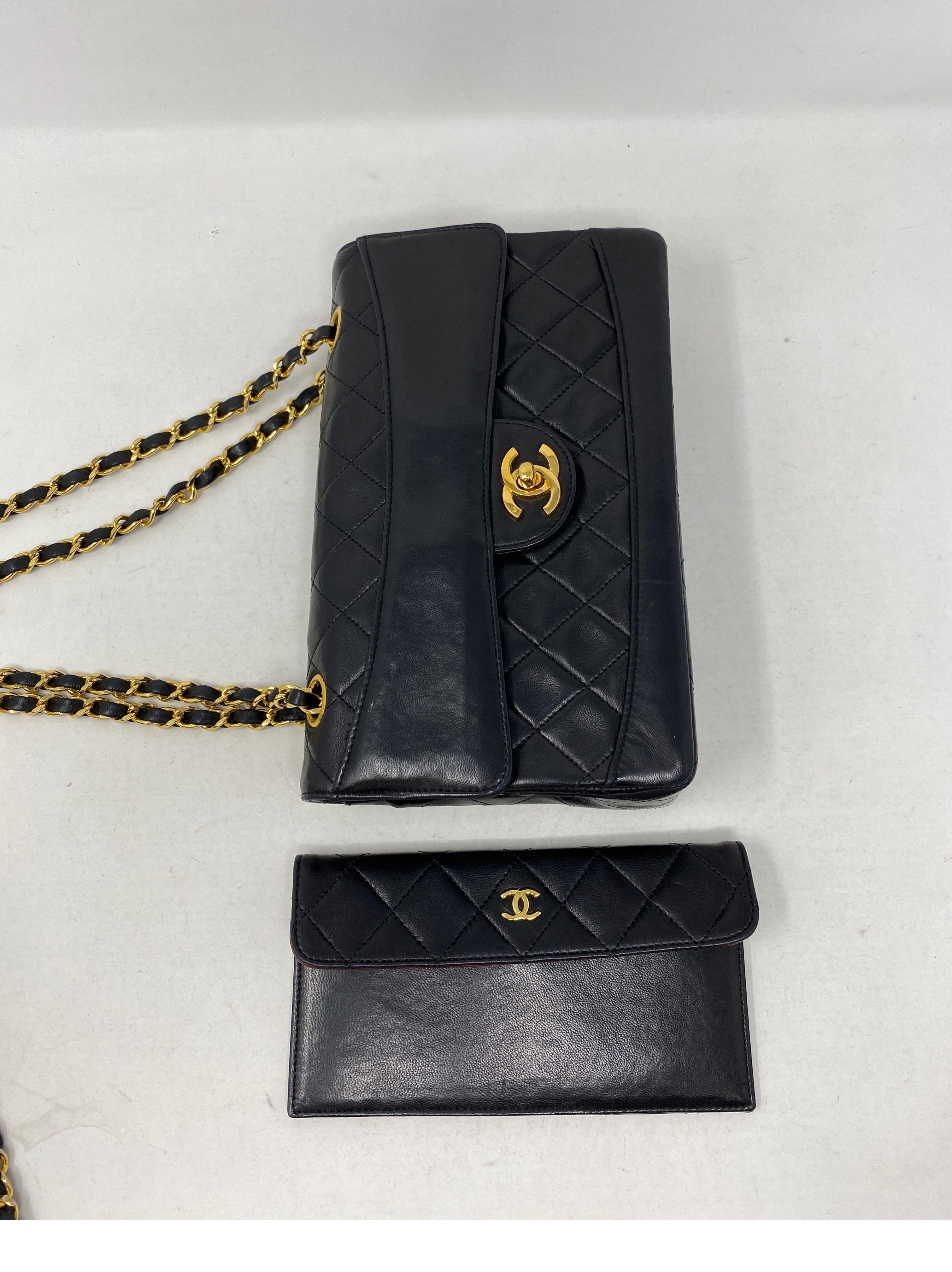 Chanel Black Flap Bag with Wallet. Black lambskin leather bag with wallet that can be attached inside with a snap. Medium size bag. Vintage bag with 24 kt gold plating on hardware and chain. Collector's piece. Great condition. Has slight must odor