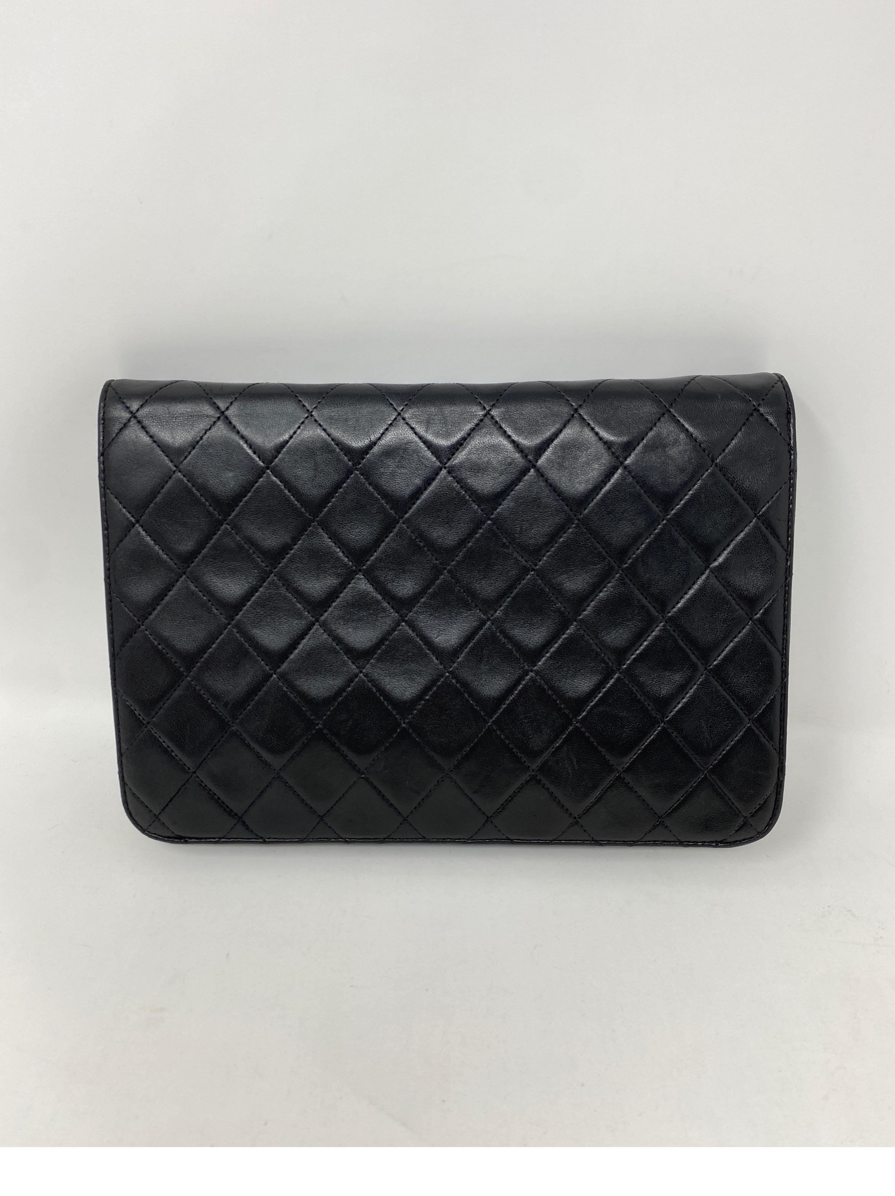 Chanel Black Leather Bag with Gold Chain Strap. Vintage bag in good condition. Lambskin leather. 24 kt gold plating on hardware and chain. Can be worn as a clutch or as a shoulder bag. Includes authenticity card. Guaranteed authentic. 