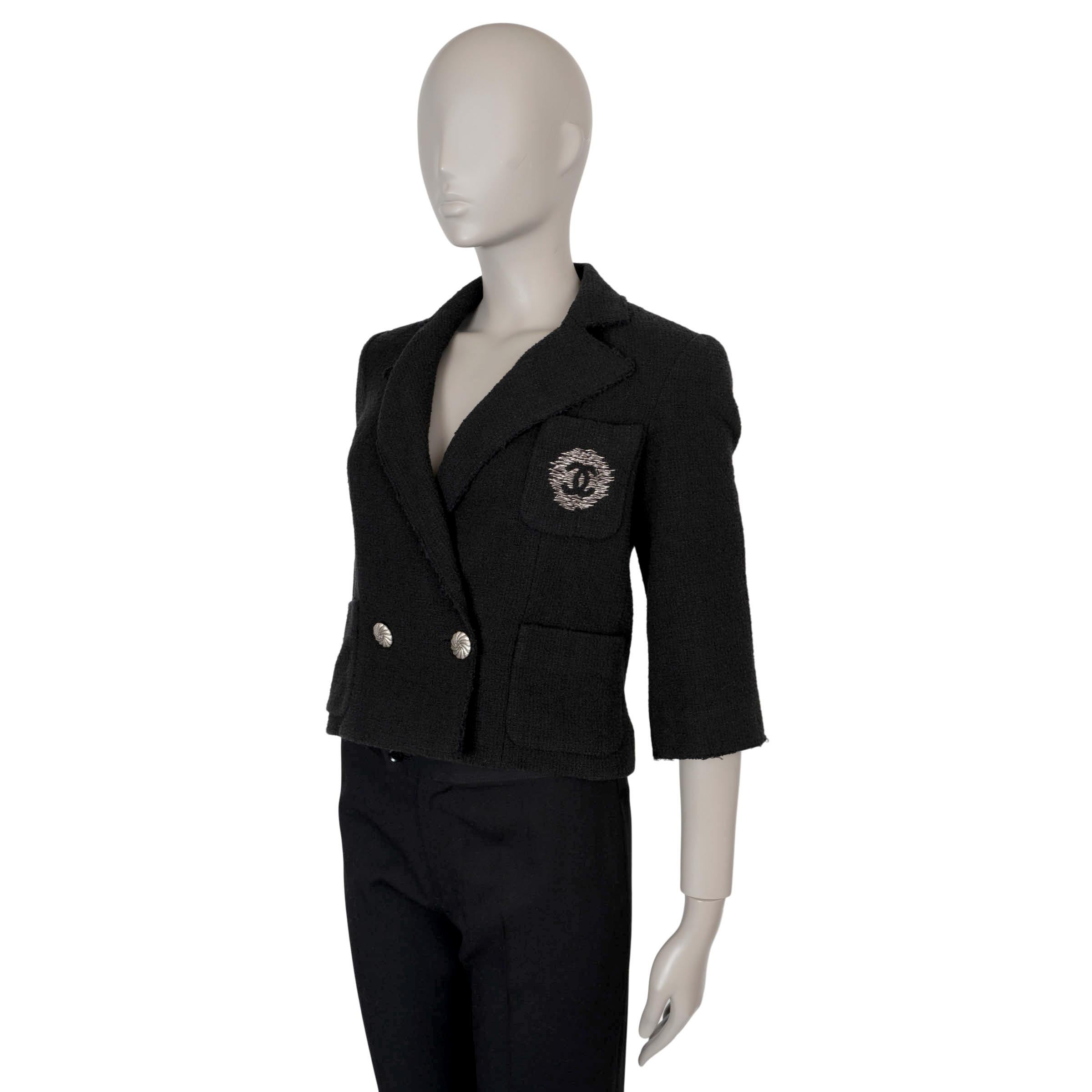 This 100% authentic Chanel double-breasted blazer in black tweed cotton embodies classic sophistication with a modern twist. It features a cropped, fitted silhouette with notched lapels, a chest pocket adorned with an embroidered CC logo, and two