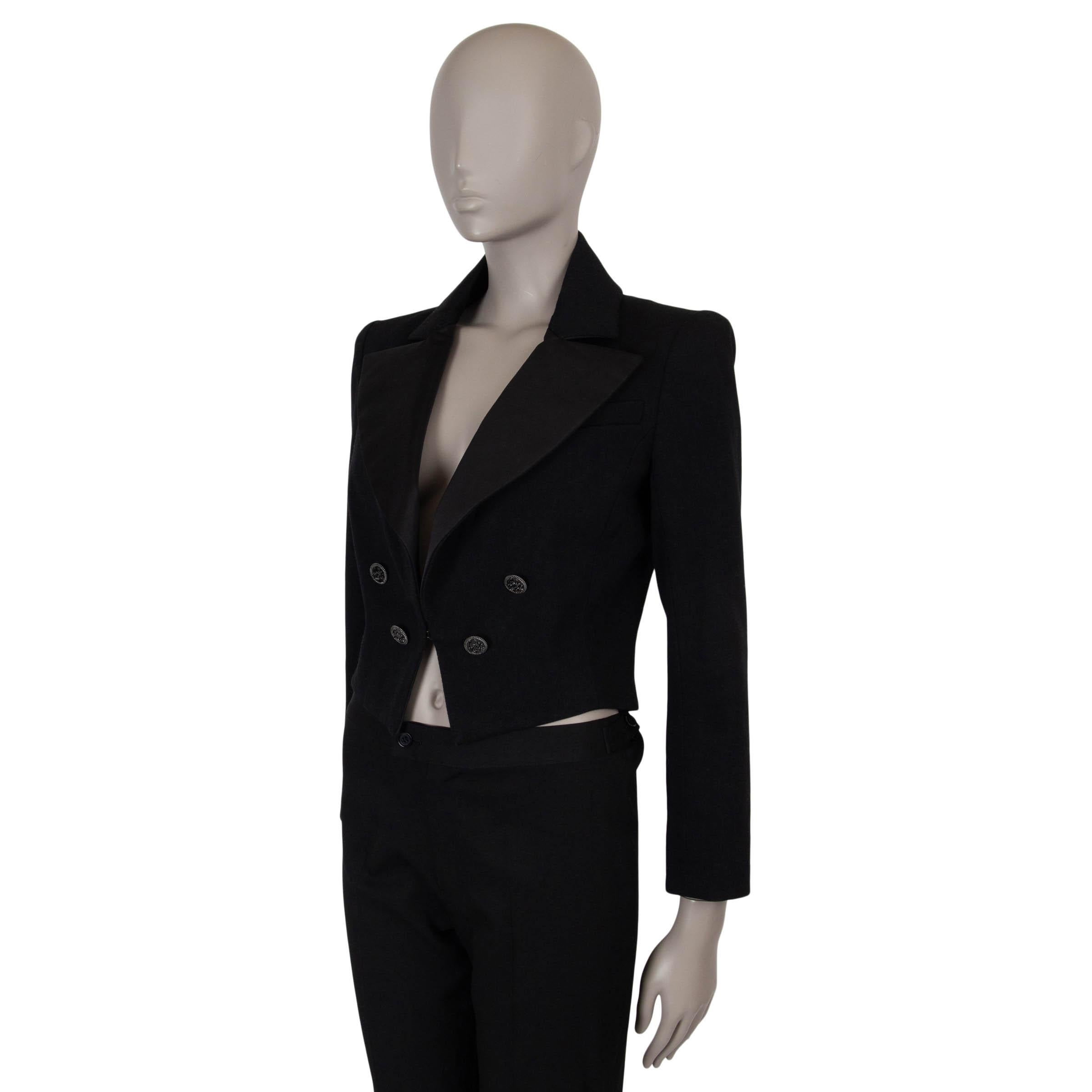 This 100% authentic Chanel tuxedo jacket in black gabardine cotton (100%) embodies sophisticated elegance. Featuring a cropped, fitted silhouette, it is adorned with large silk satin lapels and four decorative gunmetal and enamel Coco Cuba buttons