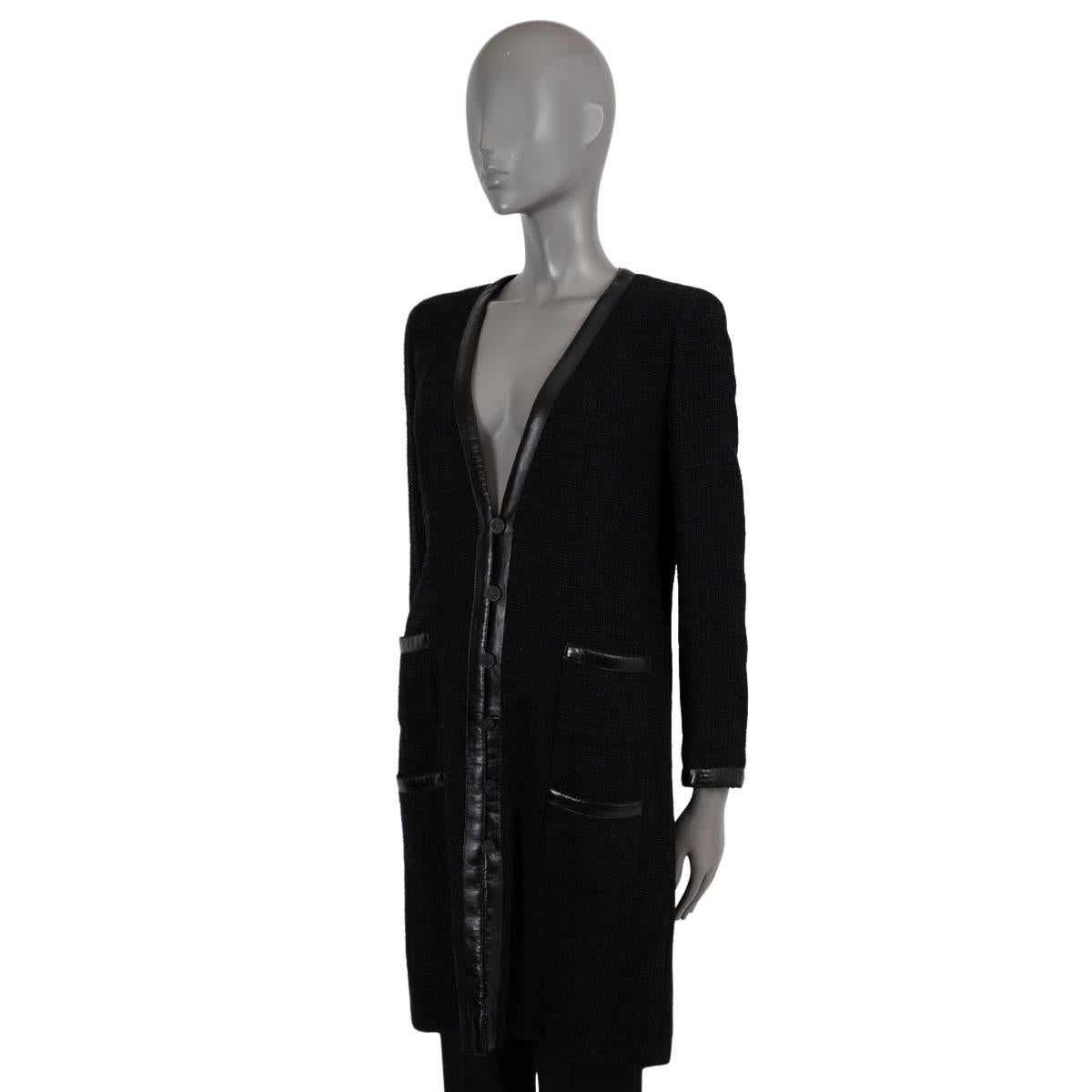 100% authentic Chanel tweed coat in black polyamide (64%), cotton (24%), rayon (7%) and linen (5%). Features leather trims along the V-neck, cuffs and pockets. Closes with black CC buttons on the front and is lined in silk (100%). Has been worn and