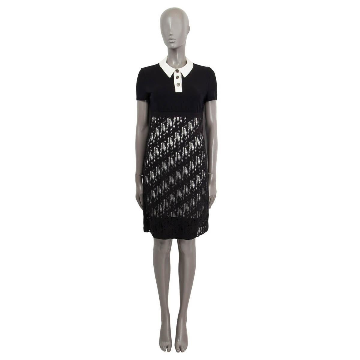 100% authentic Chanel knit dress in black and white cotton (33%), viscose (30%), nylon (20%) and polyester (17%). Features a collared collar with three buttons, short sleeves and a distressed knit overlay at the skirt. Closes with a concealed zipper