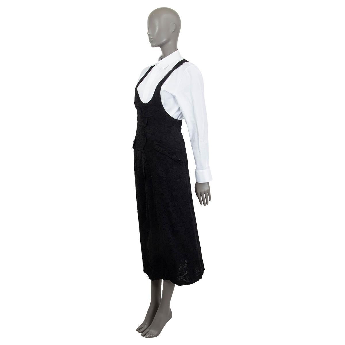 100% authentic Chanel Spring/Summer 2015 racerback lace dress in black cotton (82%) and polyester (18%). Features two flap pockets on the front. Has a slit on the front. Opens with a zipper and a hook at the back. Lined in black silk. Has been worn