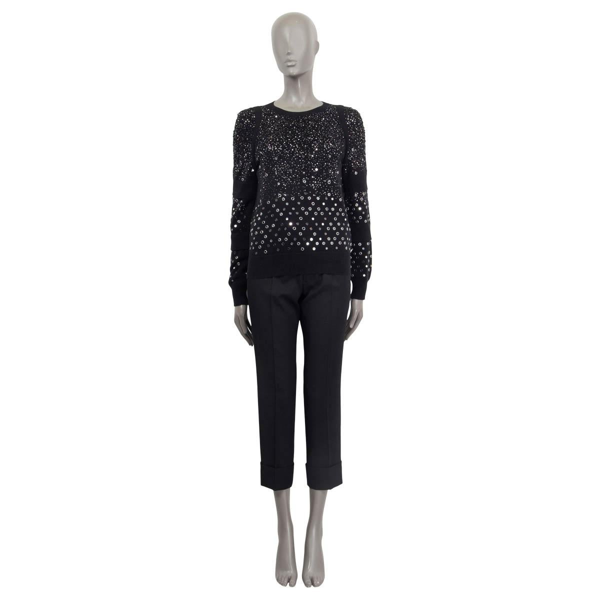 100% authentic Chanel Fall/Winter 2017 long sleeve sweater in black cotton (100%). Features cut out details on the shoulder and the bust. Embellished with studs, glitter and with ruffles on the sleeves. Unlined. Has been worn and is in excellent