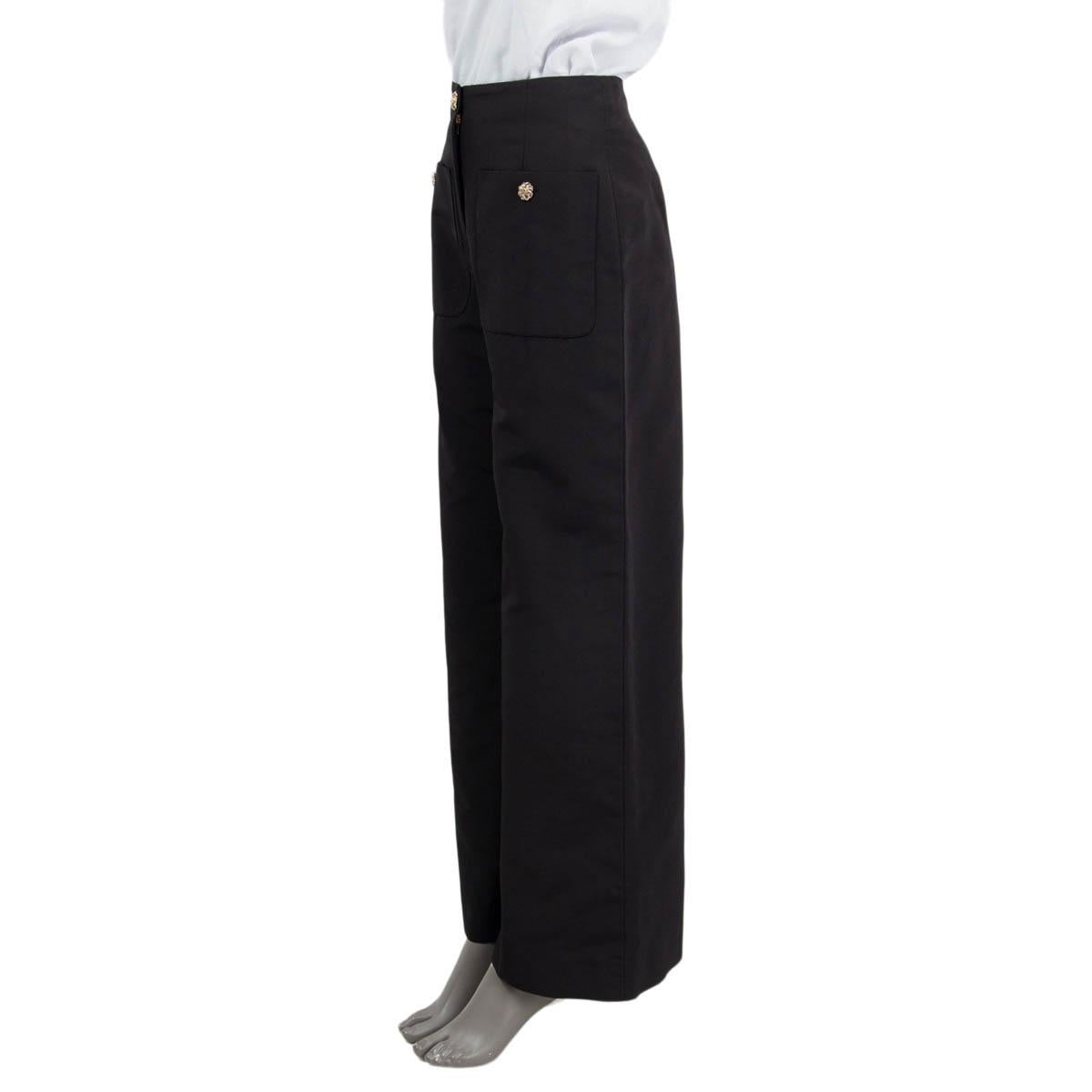 100% authentic Chanel 2020 Rue Cambon Metiers d'Art wide leg pants in black cotton (56%) and silk (44%). Feature two 'CC' buttoned patch pockets on the front. Open with a 'CC' and a zipper on the front. Unlined. Have been worn once and are in