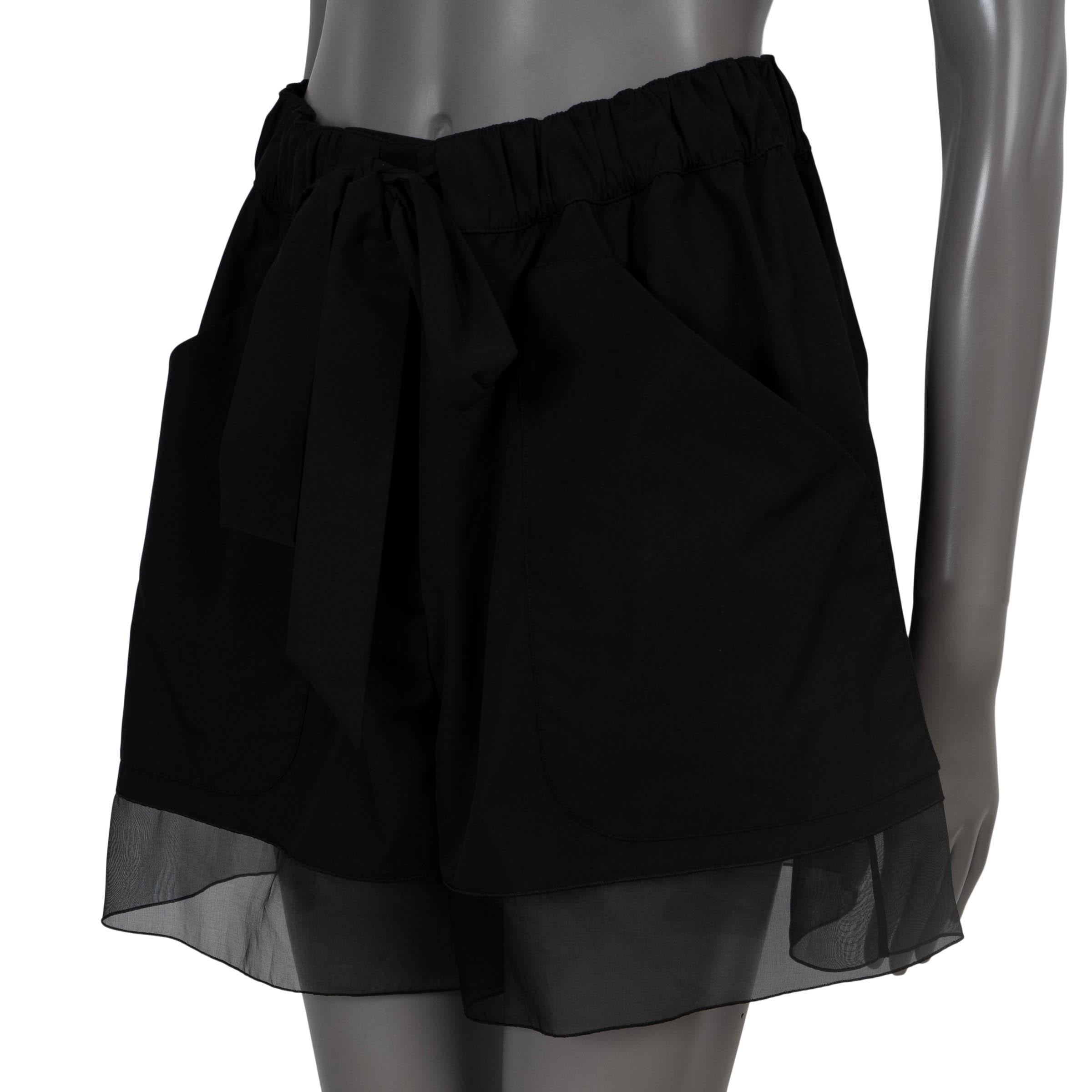 100% authentic Chanel belted shorts in black polyester (65%) and cotton (35%). Features silk chiffon trim (100%) and patch pockets. Closes with a CC button and concealed zipper on the front. Unlined. Have been worn and are in excellent