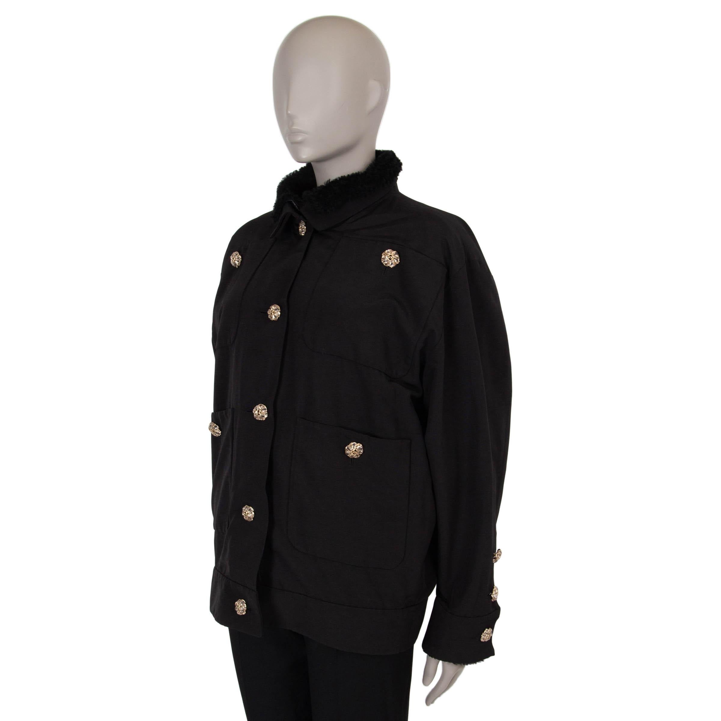 This 100% authentic Chanel jacket in black faille cotton (56%) and silk (44%) features a removable sleeveless black shearling lining for added warmth and style. Designed with a boxy oversized cut, it includes a high collar, four buttoned patch