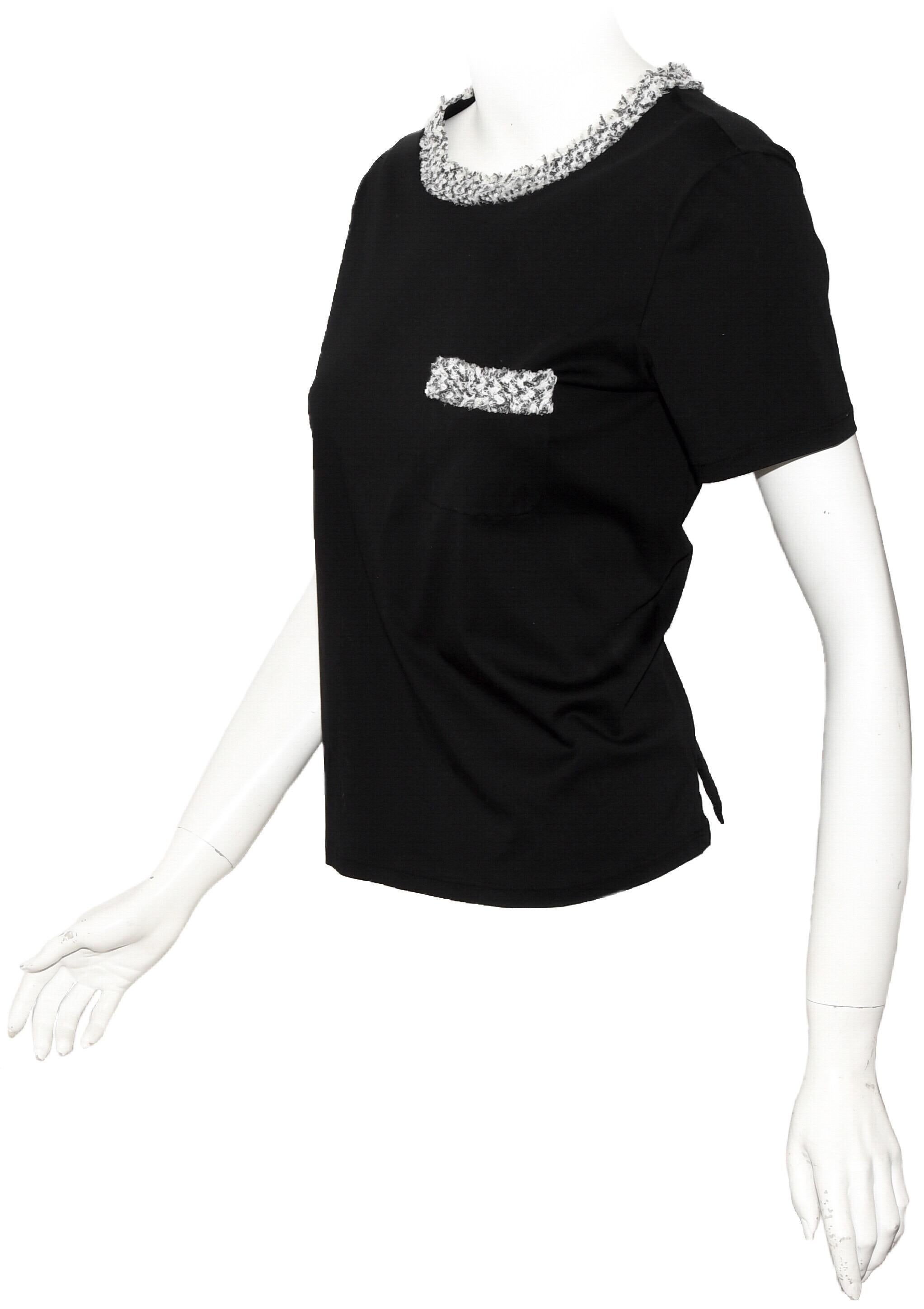 Chanel black cotton short sleeve T shirt contains black and white tweed trim around collar and chest pocket.   This top is not lined.   For closure, a small peep hole at back, also, slits at each side.  This top in excellent condition.  Made in