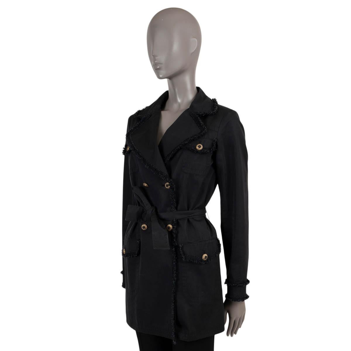 100% authentic Chanel trench coat in black cotton (70%) and silk (30%). Features frayed tweed trims, peak lapels and four buttoned flap pockets. Closes with a double row of buttons and matching self-tie belt and is unlined. Has been worn and is in