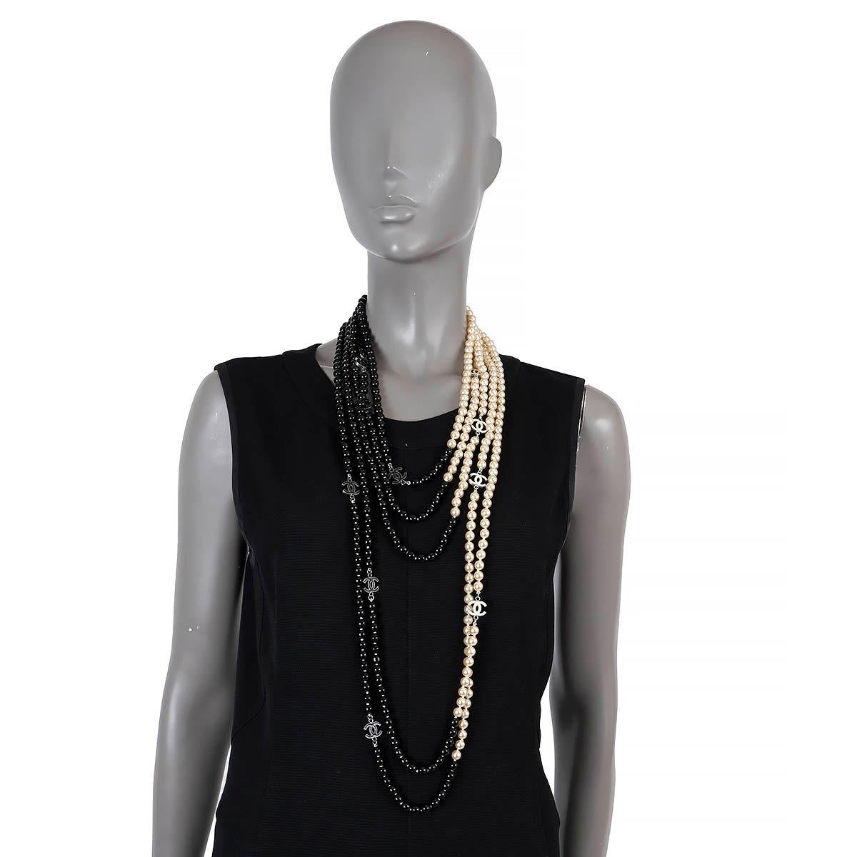 100% authentic Chanel multi strand faux pearl necklace in black and cream adorned with CC pendants. Adjustable chain closure. Has been worn and is in excellent condition. 

2005 Spring/Summer

Measurements
Model	05P
Length	60cm (23.4in)

All our