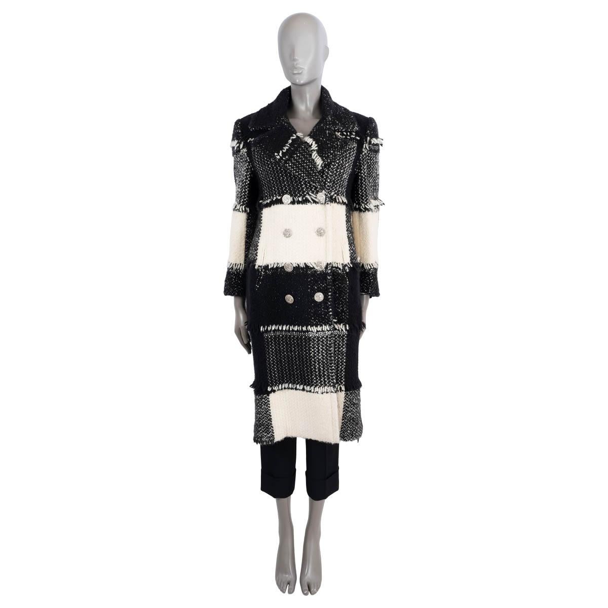 100% authentic Chanel double-breasted patchwork coat in ivory and black cashmere (67%), wool (25%), silk (5%) and polyamide (3%). Features a peak lapel and fringe trims. Closes with silver-tone antique coin buttons. Lined in silk (100%). Has been