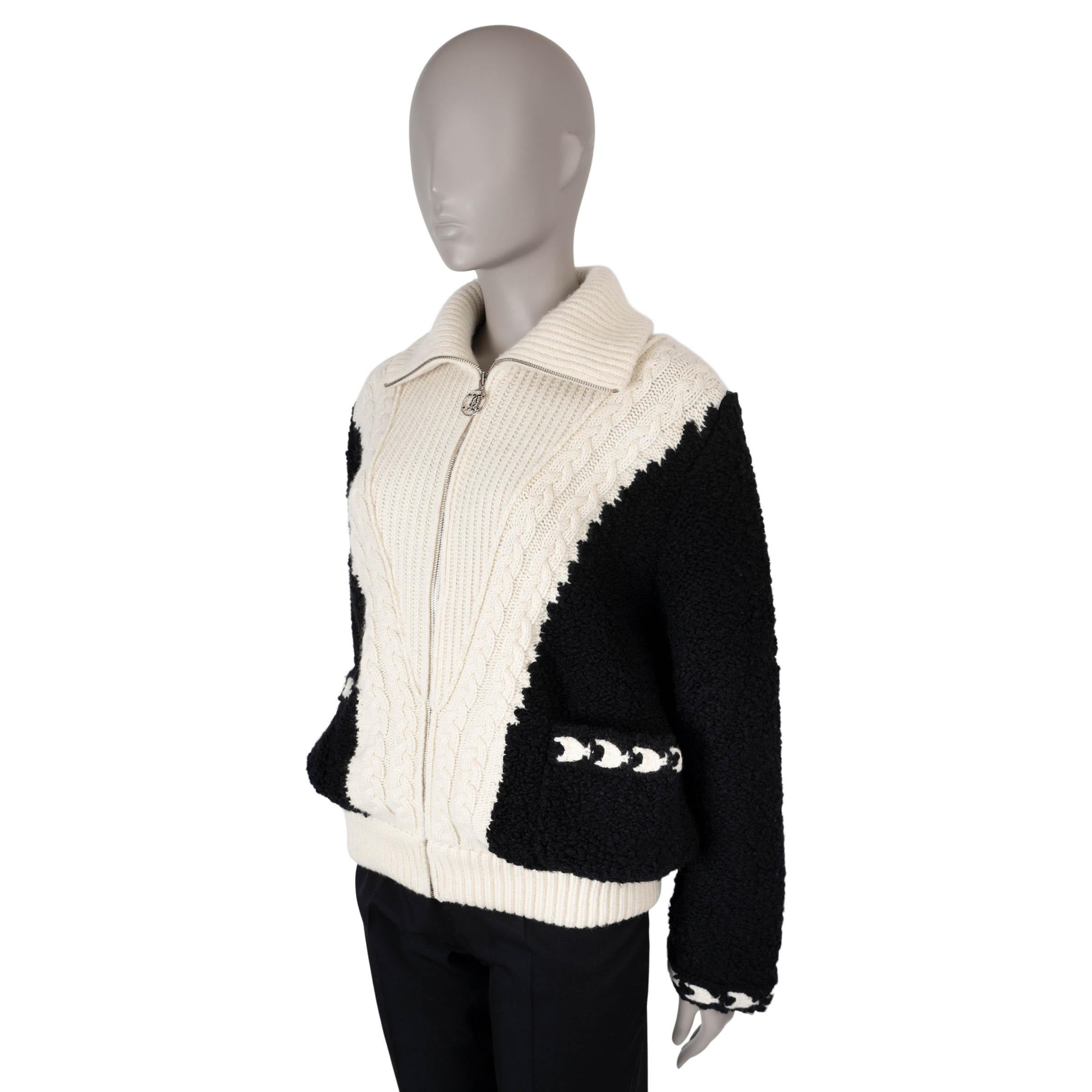 This 100% authentic Chanel bouclé and knit bomber is crafted from a luxurious blend of black and cream wool (84%) and cashmere (16%). It features cream cable-knit trimmed rib-knit panels, a high neck, pockets, and rib-knit trims for added texture