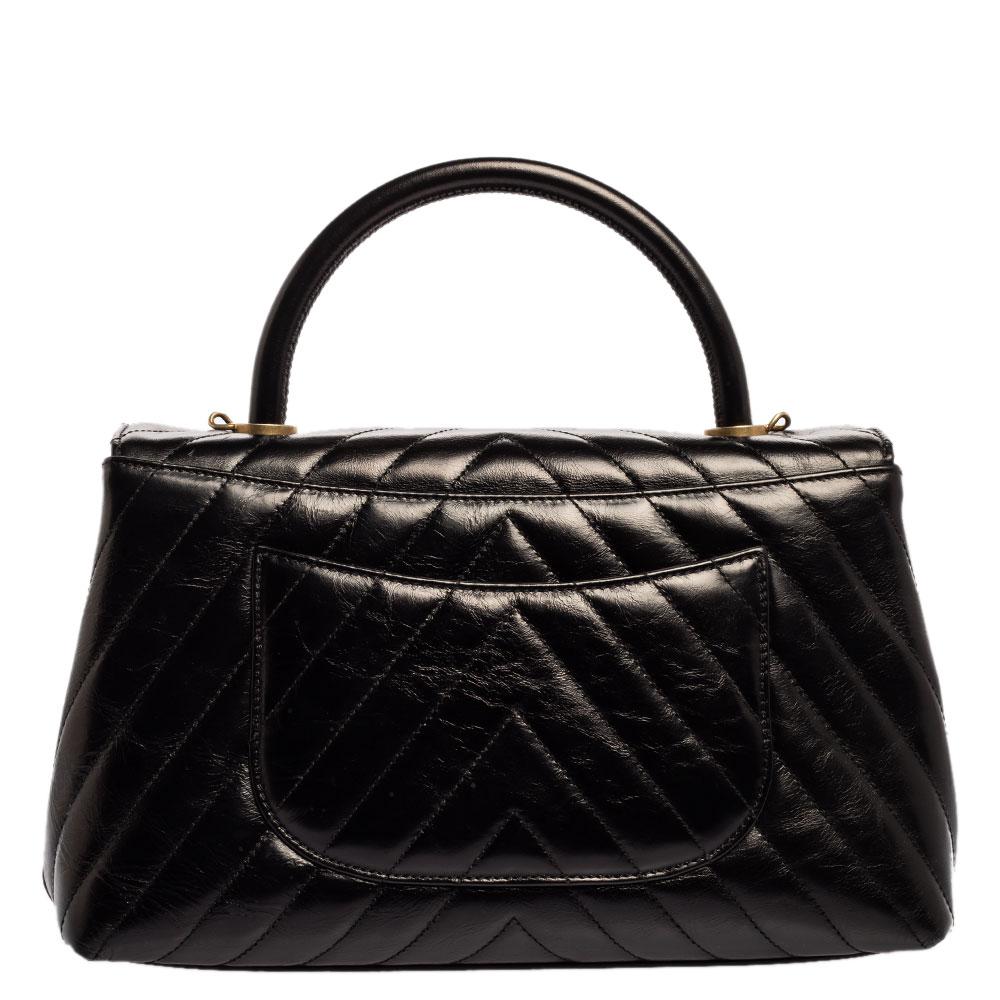 The Coco bag from Chanel is truly timeless, extremely desirable, and utterly high on style. The black beauty is crafted from crinkled leather and enhanced with a chevron-quilted pattern. The bag flaunts a top handle and a detachable shoulder strap