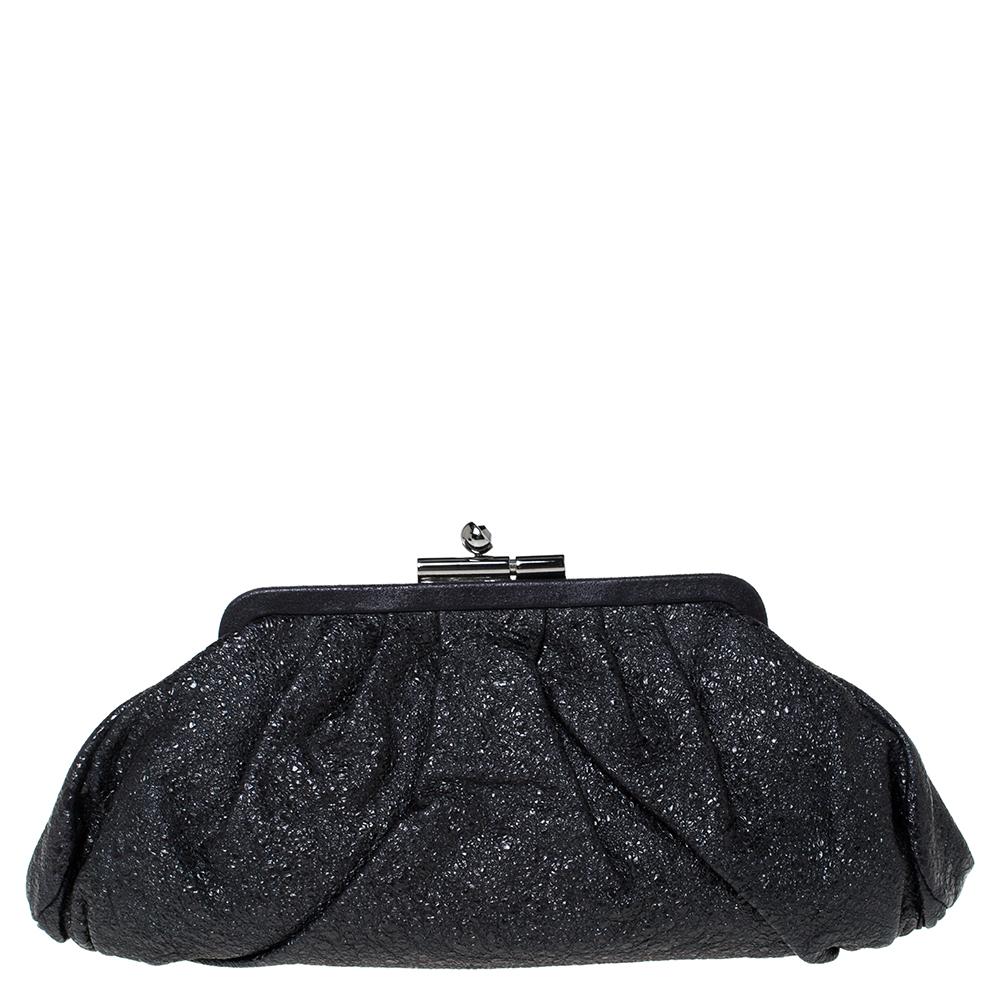 How gorgeous is this Monte Carlo clutch by Chanel! It has a slouchy, gathered-like silhouette which is overflowing with style. From the way it has been crafted to the way it has been designed, this clutch makes a loud fashion statement with every