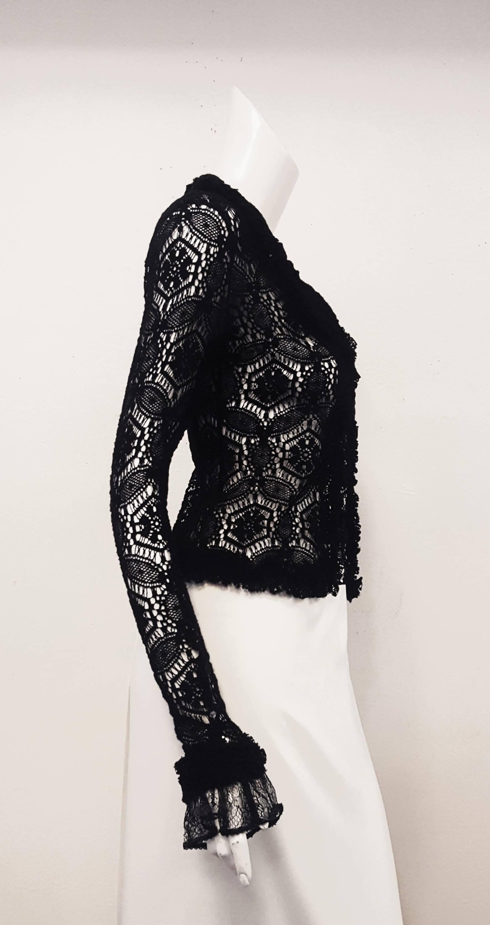
Chanel Vintage black crochet jacket features a notched double collar and lapel.  Open front no buttons nor hook & eye.  Charming knitted ribbon trim around collar, lapel, hem and cuffs decorates the jacket.   Cuffs, also, have a lace trim coming