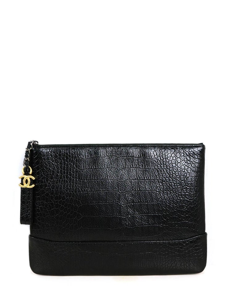 Chanel Black Crocodile Embossed Gabrielle O-Case Wristlet Bag.  Features wristlet with goldtone CHANEL goldtone metal lettering.

Made In: Italy
Year of Production:2019
Color: Black
Hardware: Silvertone and goldtone
Materials: Embossed
