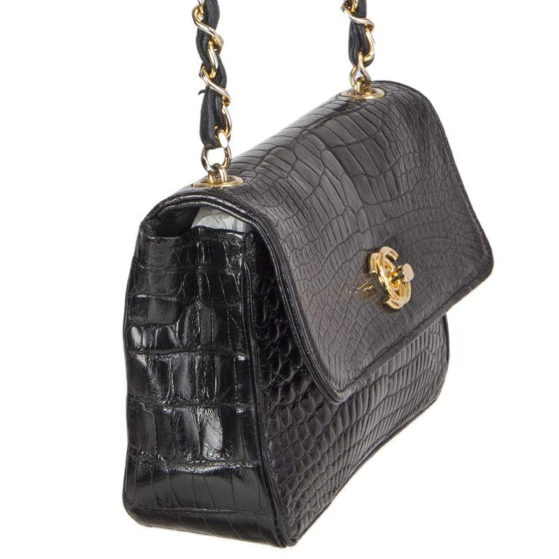 Chanel Vinatge 'Mini Flap' crossbody bag in black crocodile. Opens with a CC turn lock and is lined in black leather with once open pocket against the back. Has been carried and the insdie pockethas discoloration from something spilling. Overall