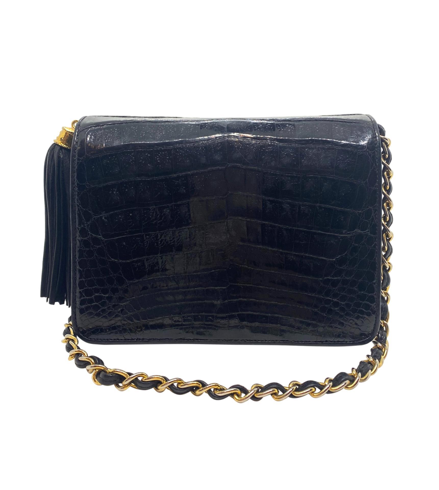 Chanel Black Crocodile Vintage Camera Tassel Bag with Gold Hardware. This extremely rare and highly sought after piece of Chanel history was one of the very first camera bags produced, baring a serial code of 