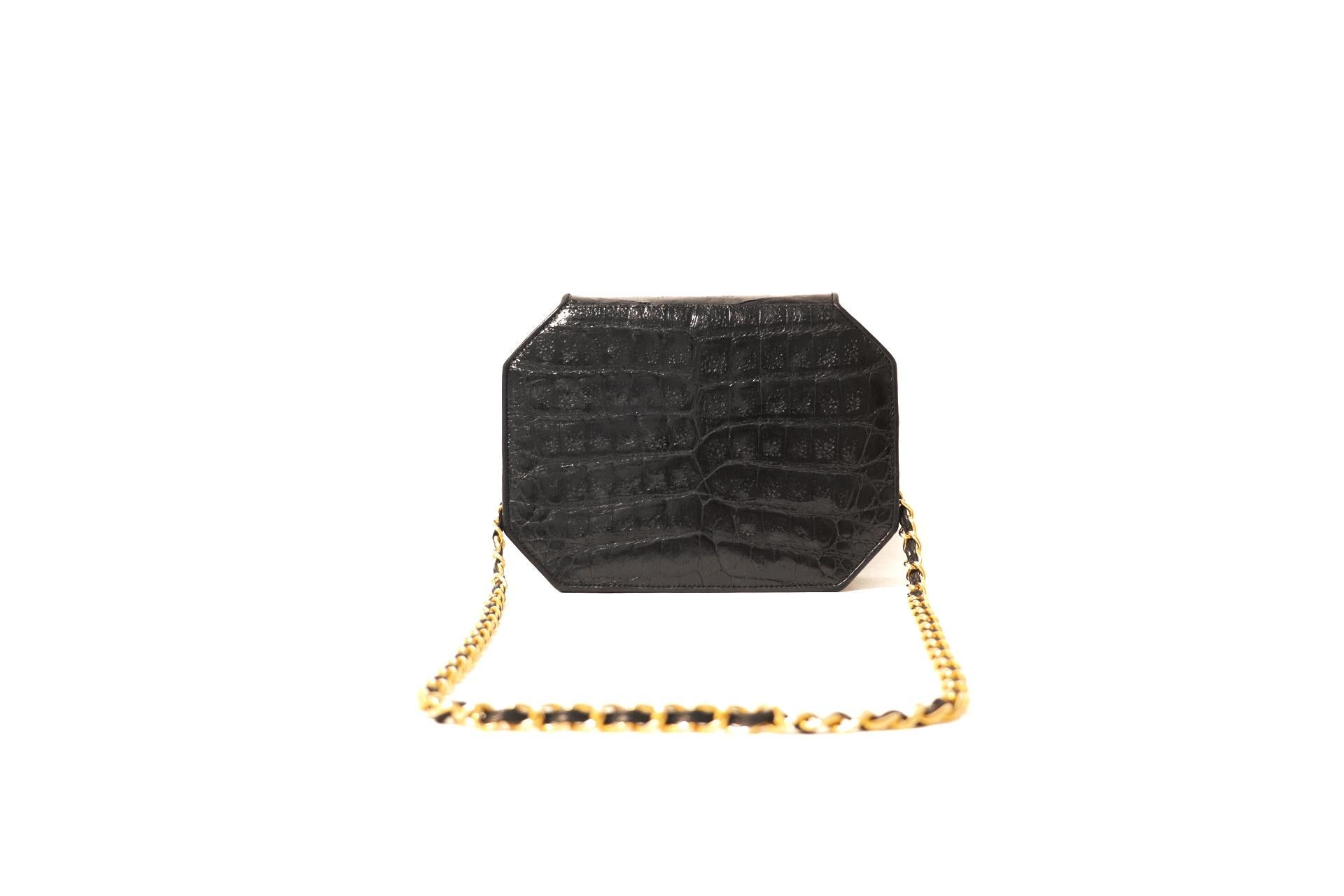 This authentic Chanel Black Crocodile Octagonal Bag is in excellent condition.  A rare vintage style, it is a beautiful addition to any collection. 
Sleek black crocodile skin is structured in an eight-sided shape.  Gold interlocking CC twist lock