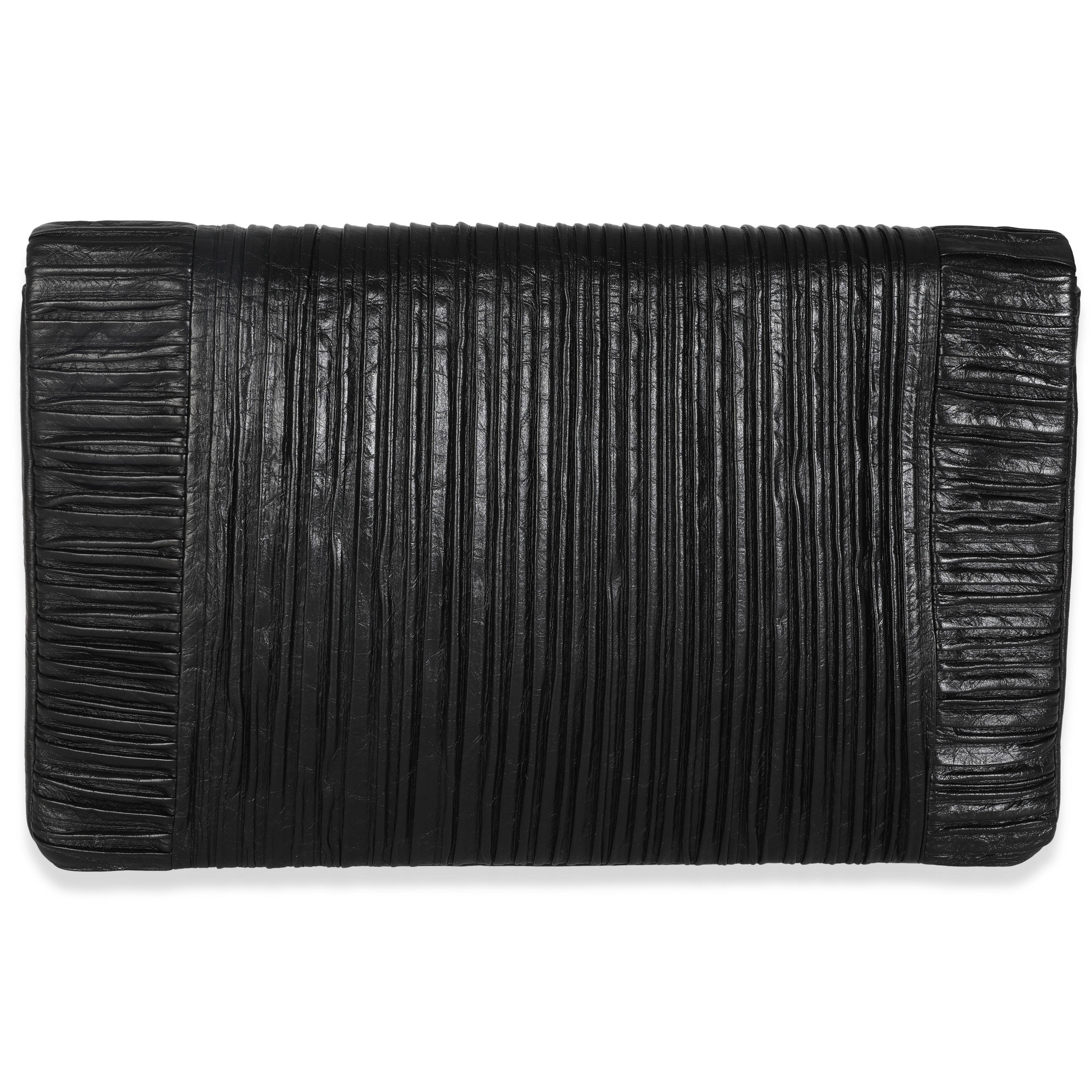 Listing Title: Chanel Black Crumpled Calfskin Coco Pleats XL Flap Clutch
SKU: 146657
Condition: Pre-owned 
Condition Description: A timeless classic that never goes out of style, the flap bag from Chanel dates back to 1955 and has seen a number of