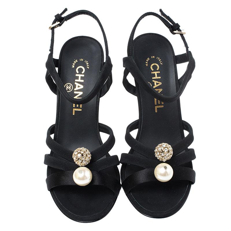 You'll find excuses to wear these gorgeous sandals from Chanel as they are all about elegance! These sandals are crafted from satin into an open toe silhouette. They feature embellishments, ankle straps, 10.5 cm heels and leather insoles.

Includes: