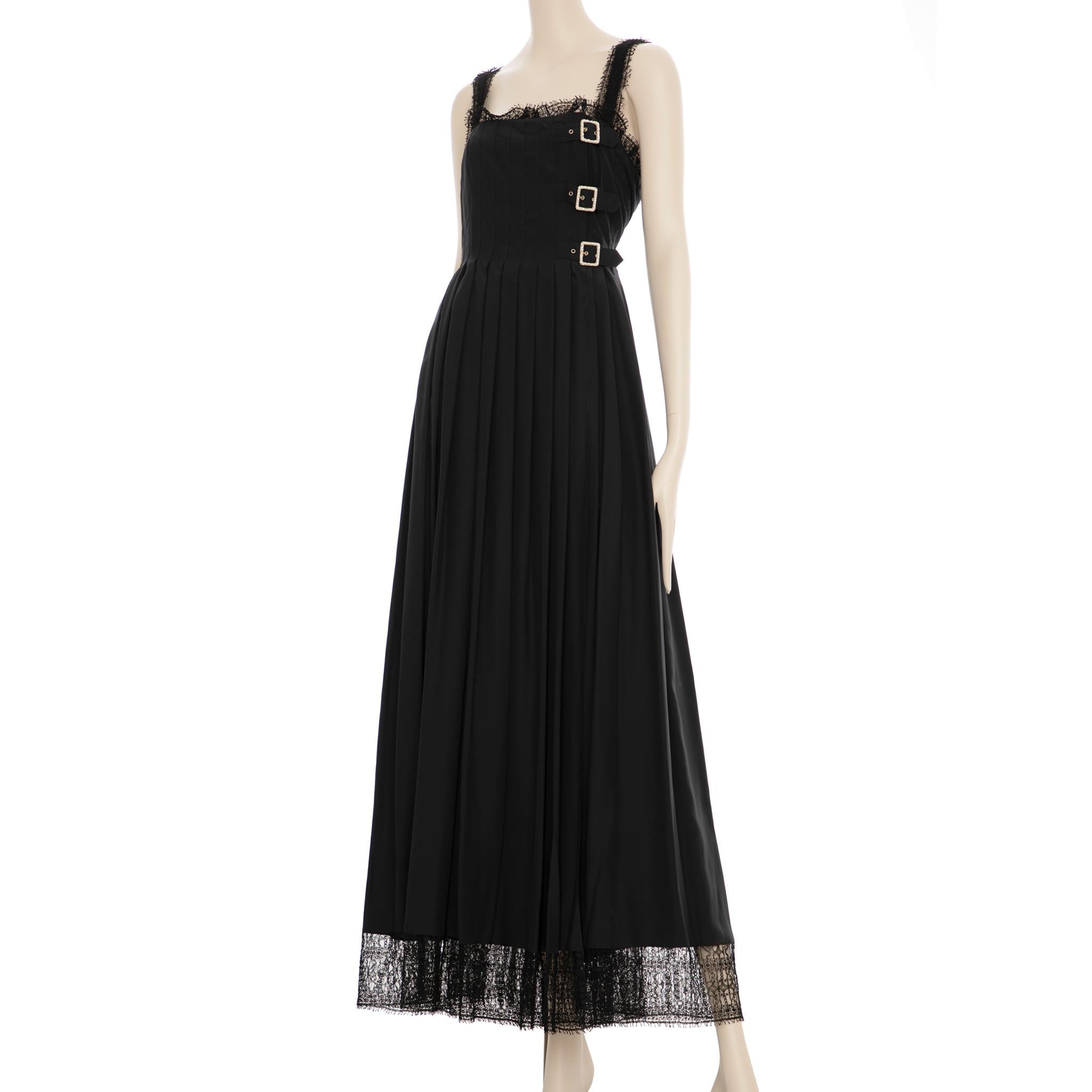 This timeless black knit dress from Chanel is perfect for layering for any occasion. The faux pearl details elevate the design for a sophisticated look. Crafted with quality materials, this dress is sure to last for many
