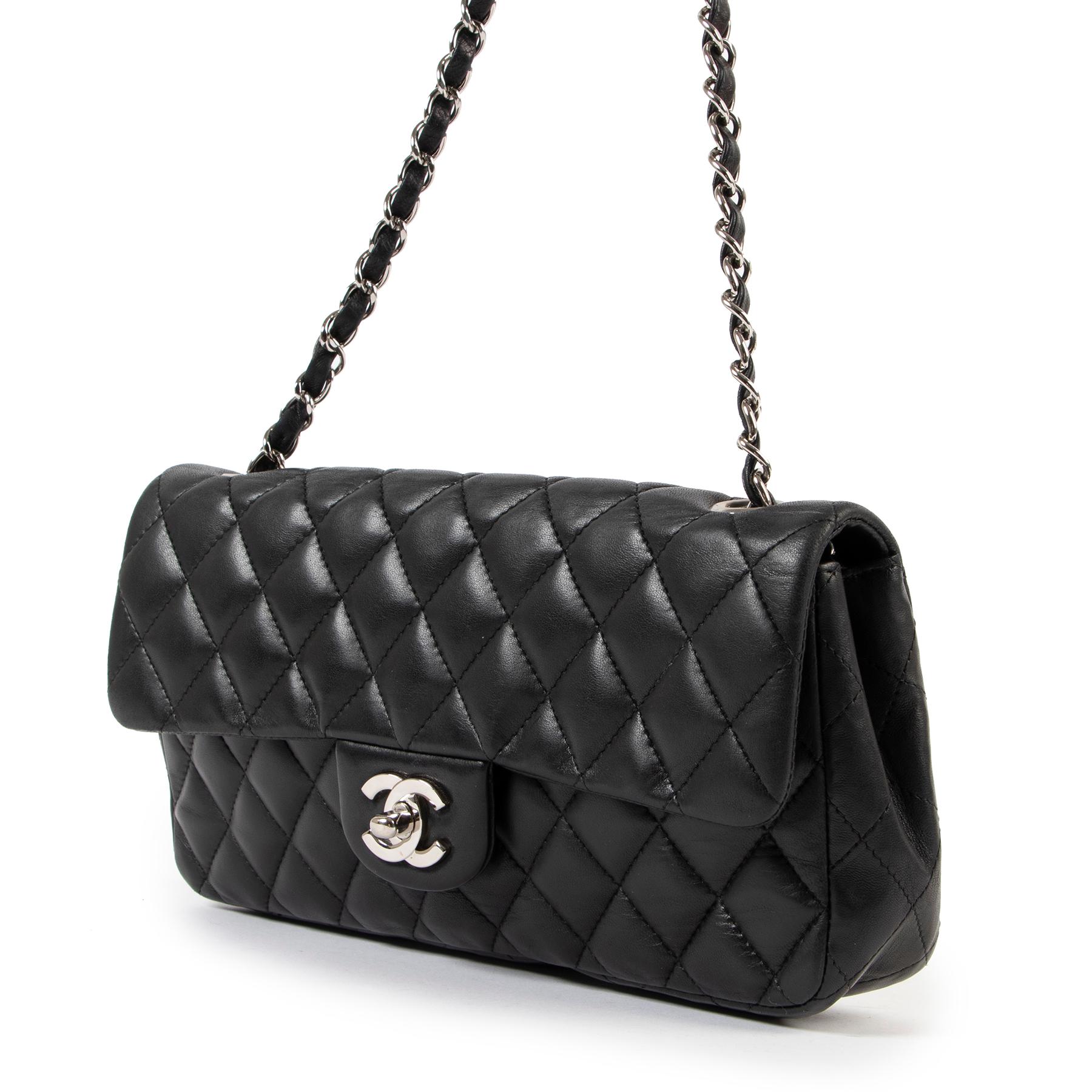 Crafted from signature diamond-quilted lambskin, this Chanel East West flap shoulder bag displays the expert craftsmanship the maison stands for. This iteration boasts timeless black color and is finished with the iconic interlocking CC turnlock in