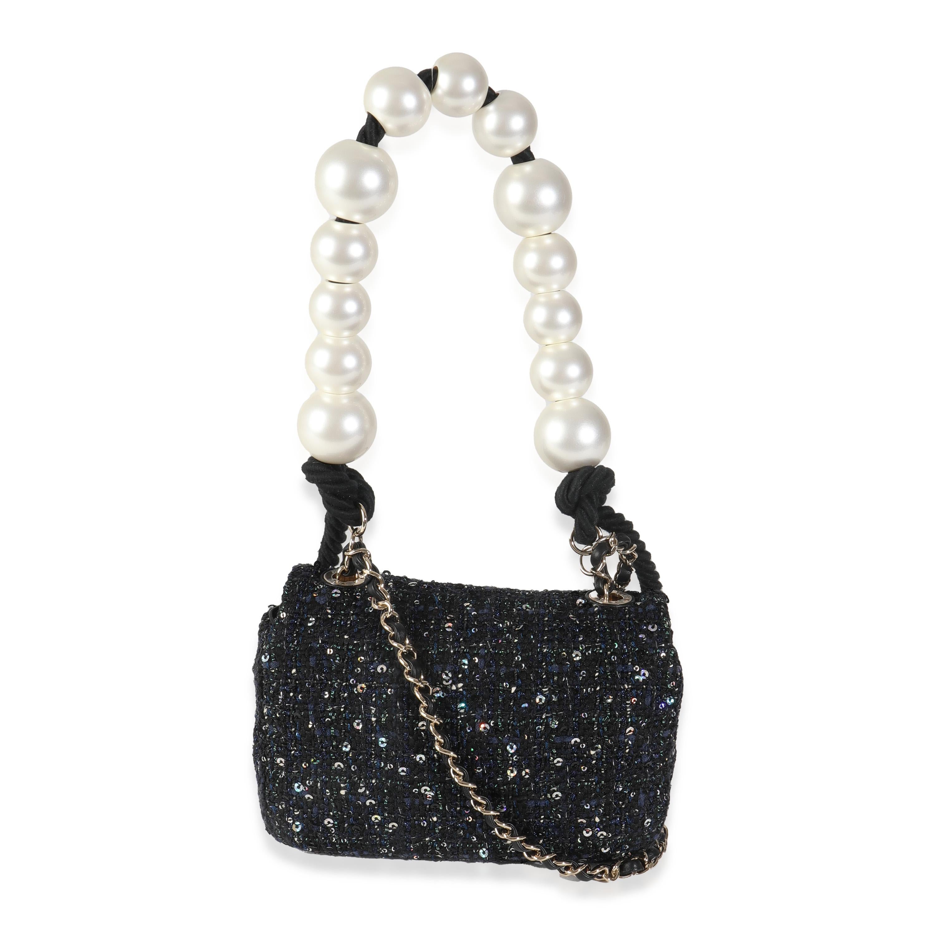 Listing Title: Chanel Black Ecru Tweed Mini Pearl Handle Flap Bag
SKU: 144813
Condition: Pre-owned 
Condition Description: A timeless classic that never goes out of style, the flap bag from Chanel dates back to 1955 and has seen a number of updates.