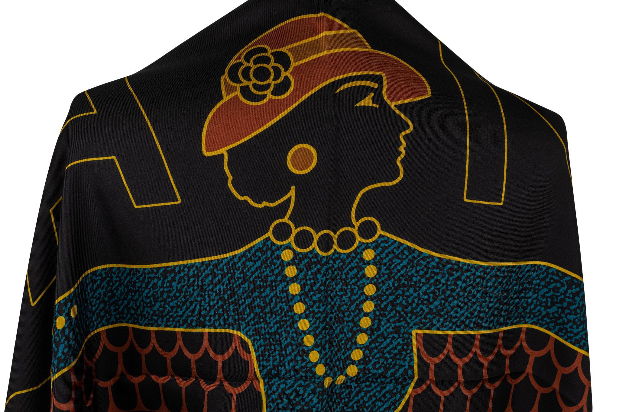 Chanel Egyptian collection black silk shawl. The piece has a red, blue and gold design with a female pharaoh. It is in new condition.