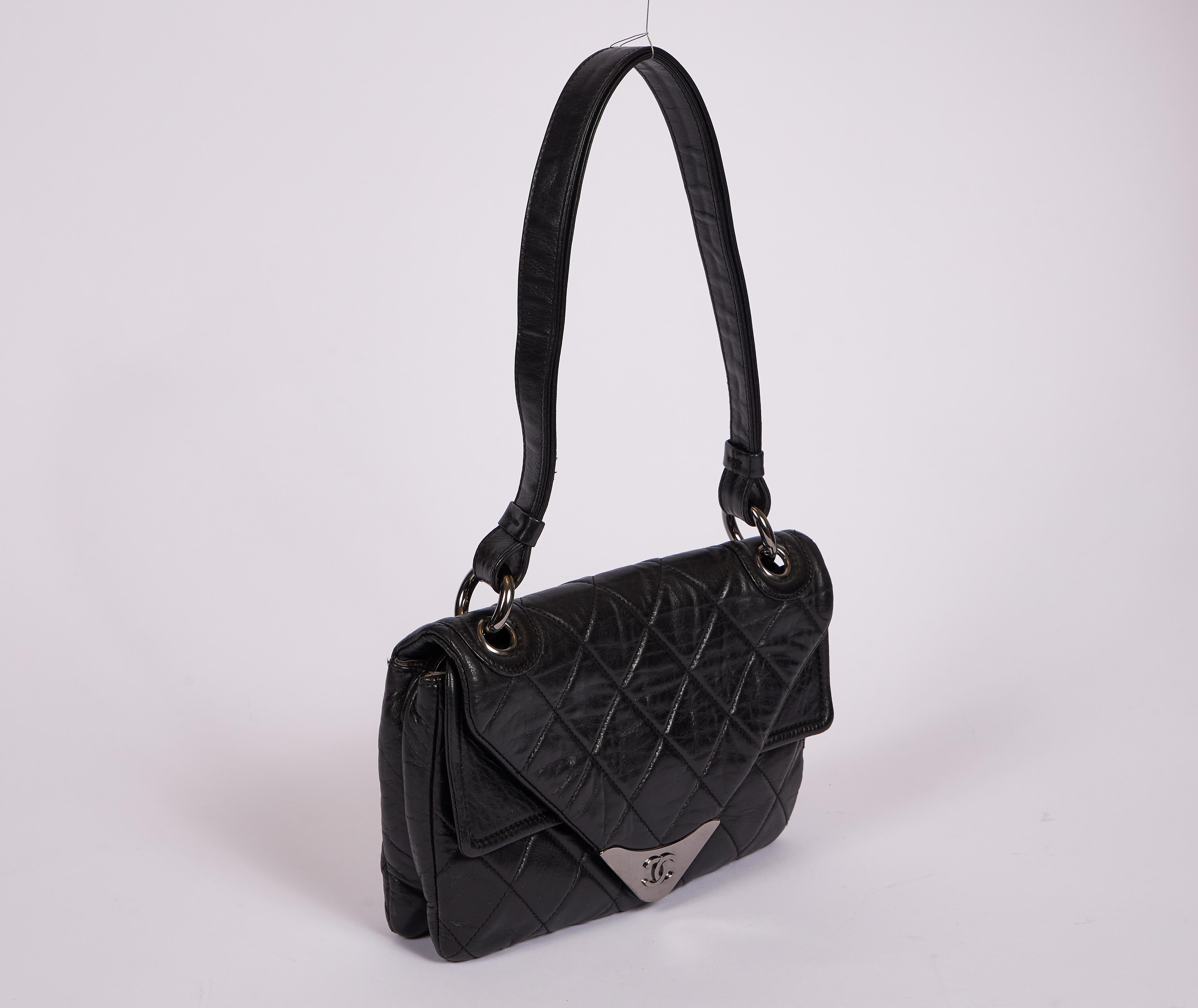 Chanel black lambskin envelope shoulder bag with silver tone hardware. Two interior compartments. Shoulder drop 10