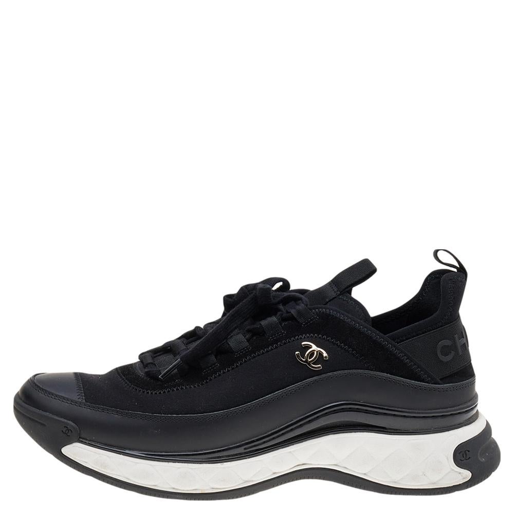 Sneakers that are as luxurious and comfortable as these are a must-have for your closet! These Sport Trail sneakers from the House of Chanel are fashioned using black fabric and leather into a sturdy silhouette. They display lace-ups and a